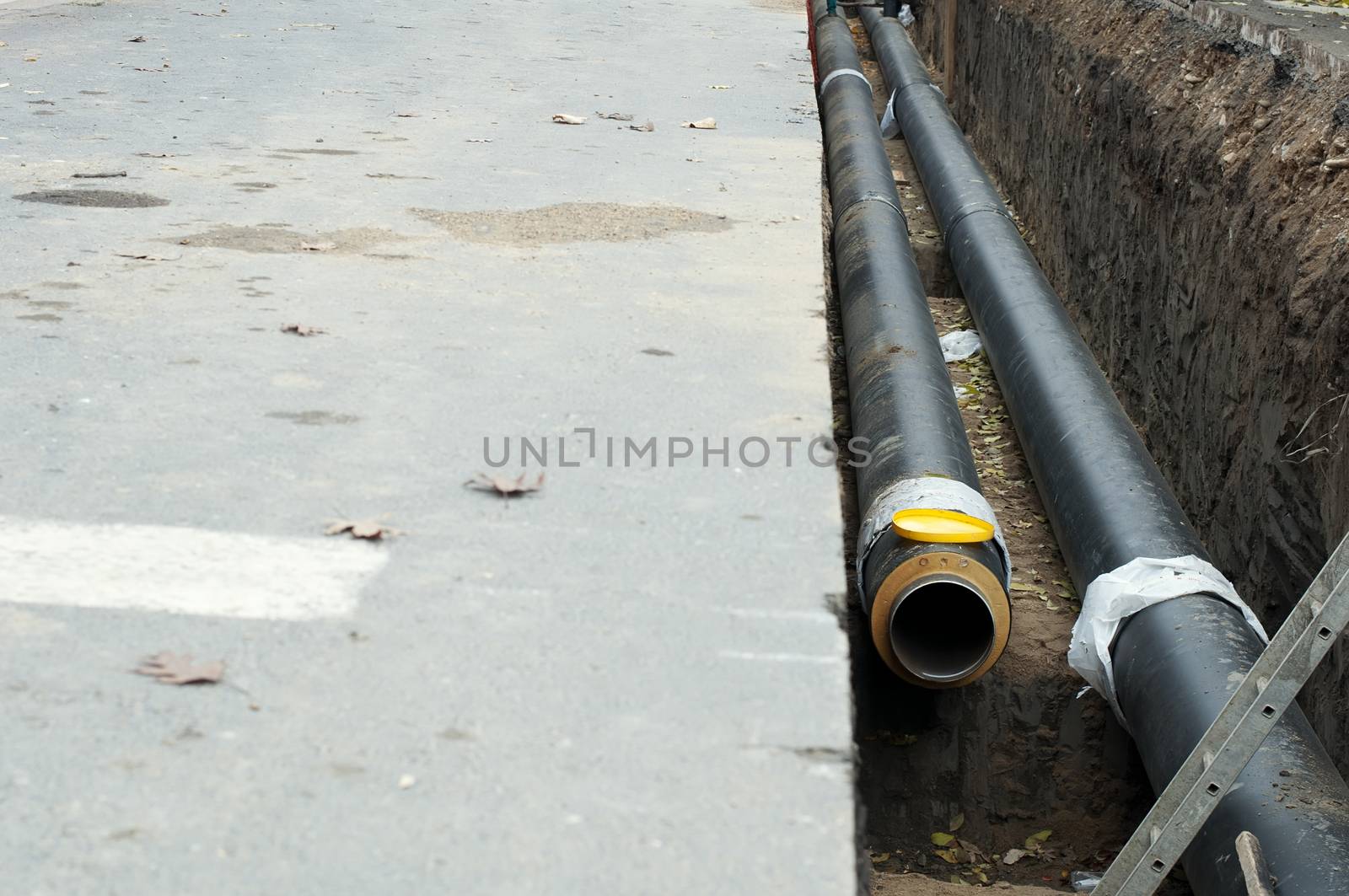 Installing pipes for hot water and steam heating. City heat pipeline