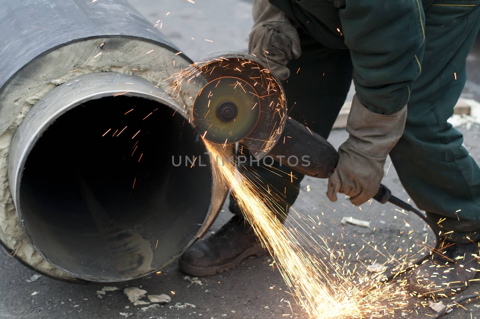 Cutting of pipes with grinder. Hot water and steam heating pipe