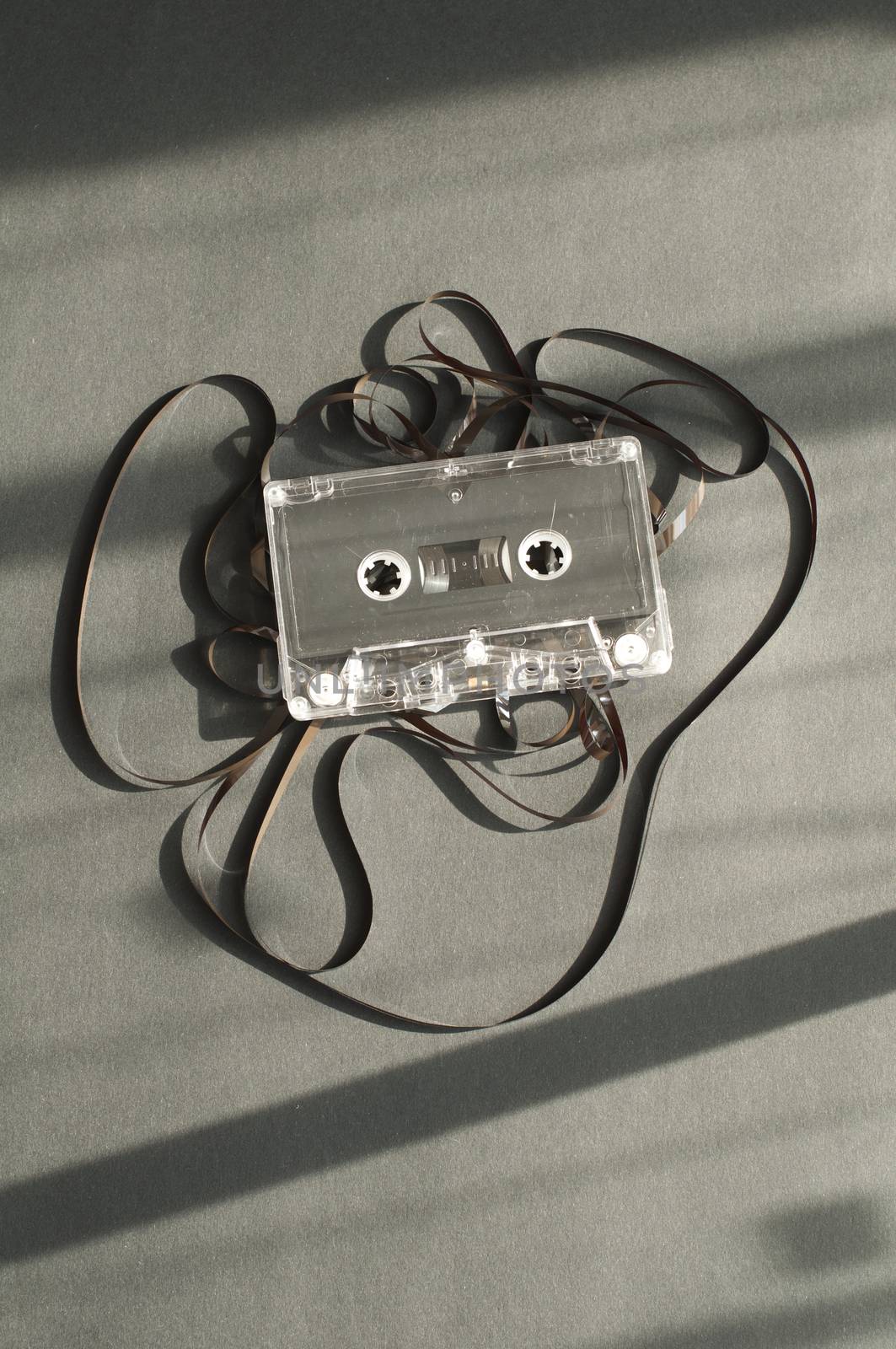 Audio tape cassette with subtracted out tape. Old broken cassette