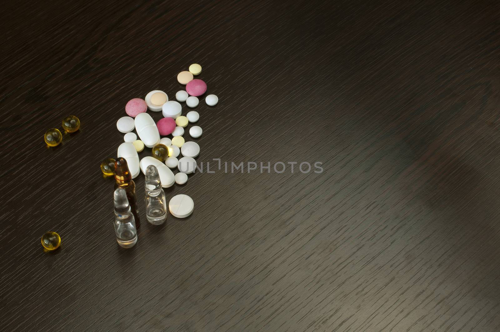 Pile drugs and ampoules on table
