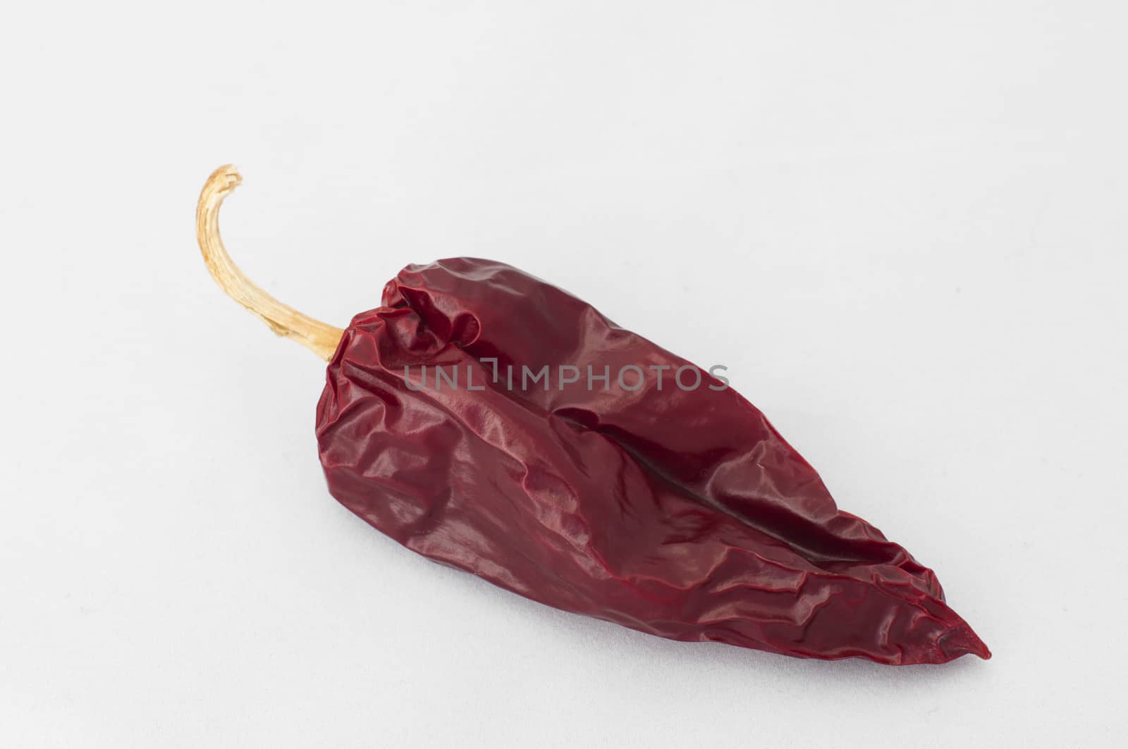 Dried big red pepper. White isolated