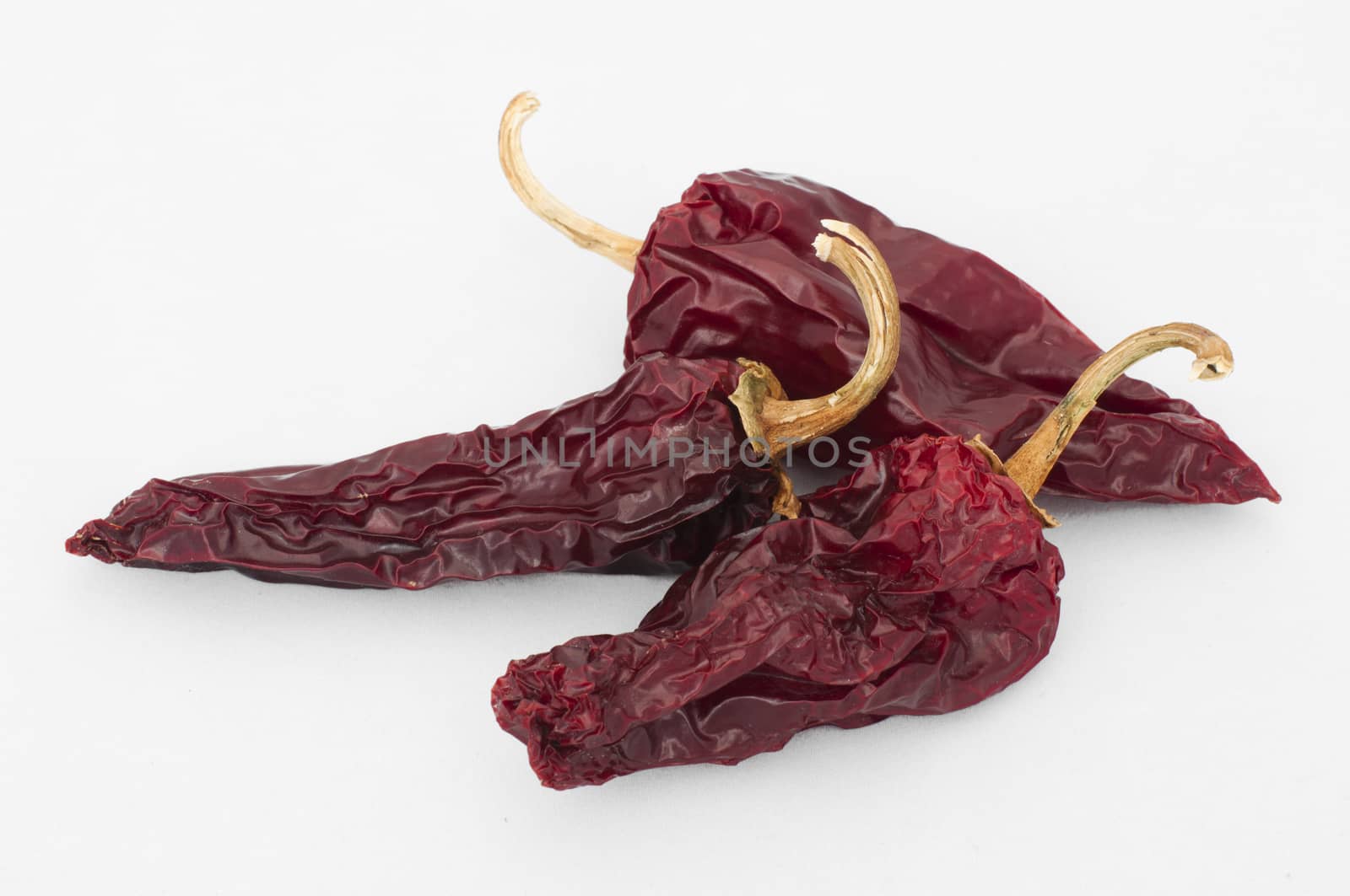 Dried big red peppers. White isolated