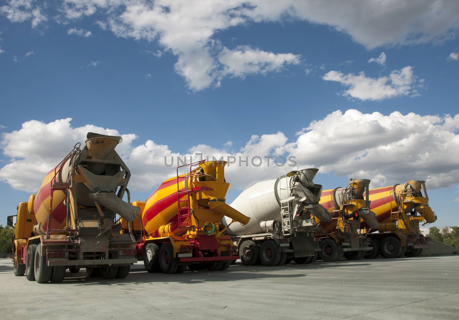 Five Cement Trucks on blue sky