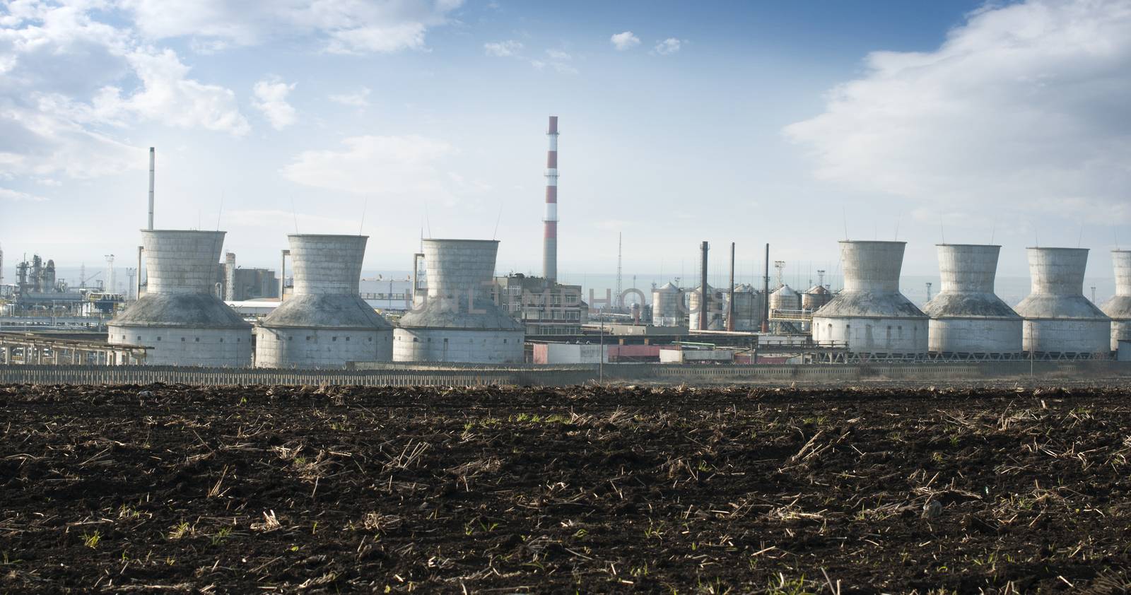 Oil and chemical refinery for production of petroleum products. Land on foreground