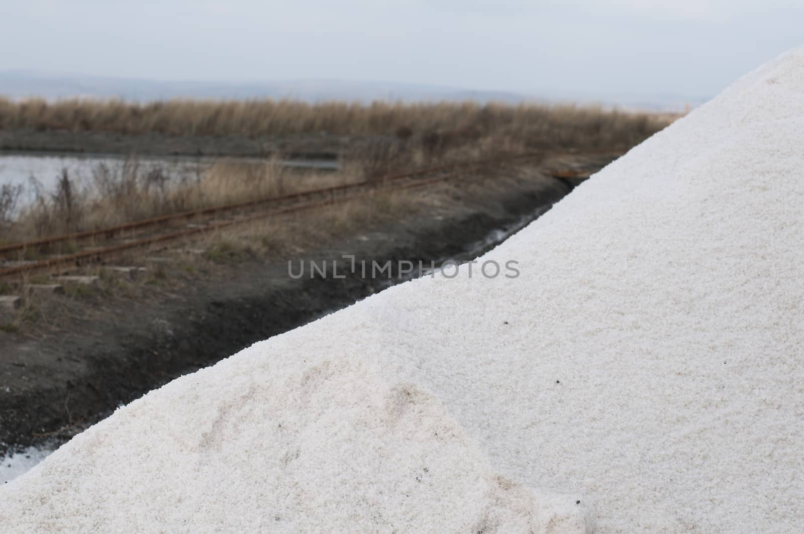 Pile white salt and seawater on background