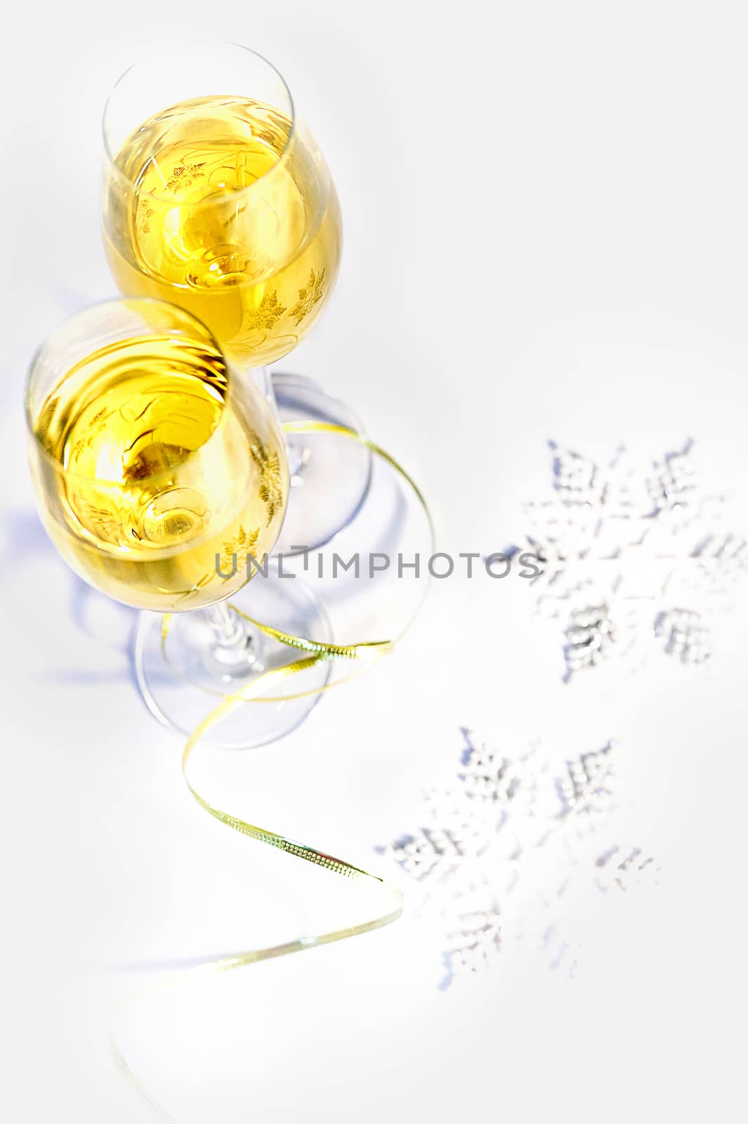 Two glasses of wine and snowflakes on a white background. Holiday concept