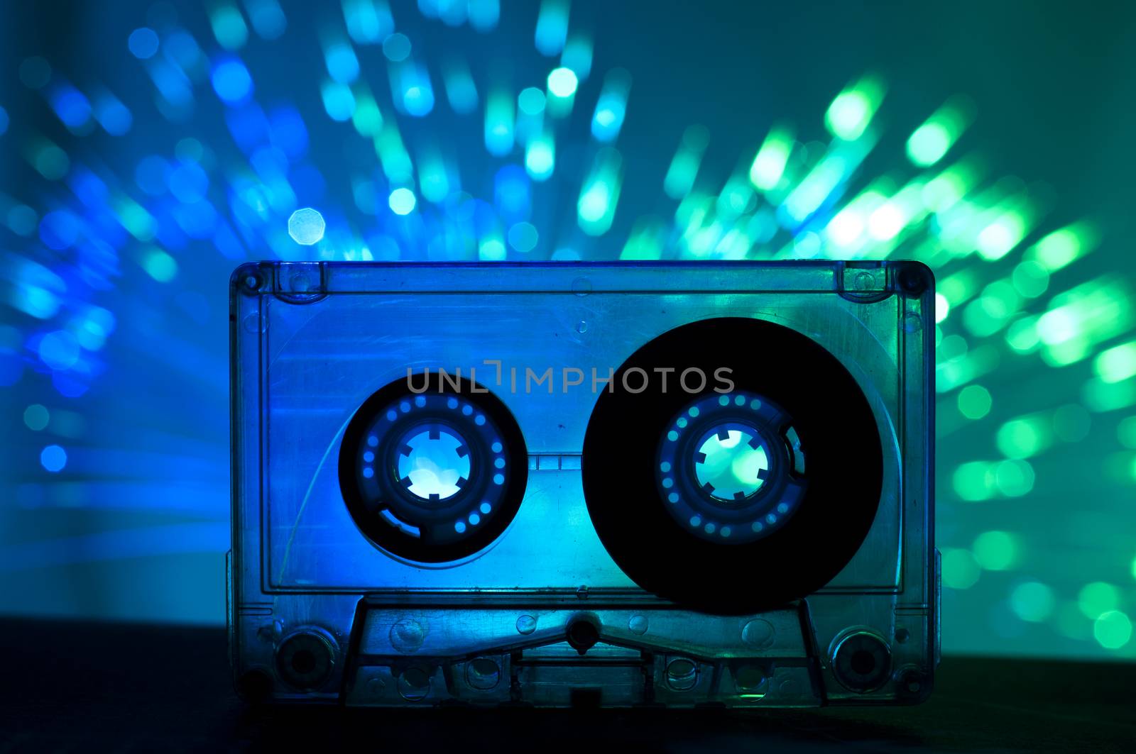 Transparent Cassette tape and disco light background by deyan_georgiev