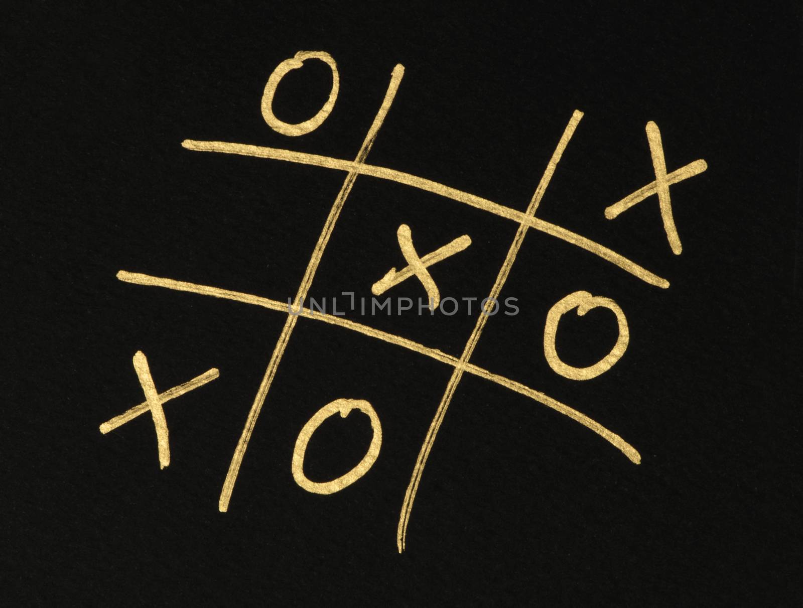 Hand-drawn tic-tac-toe game. Gold color text over black