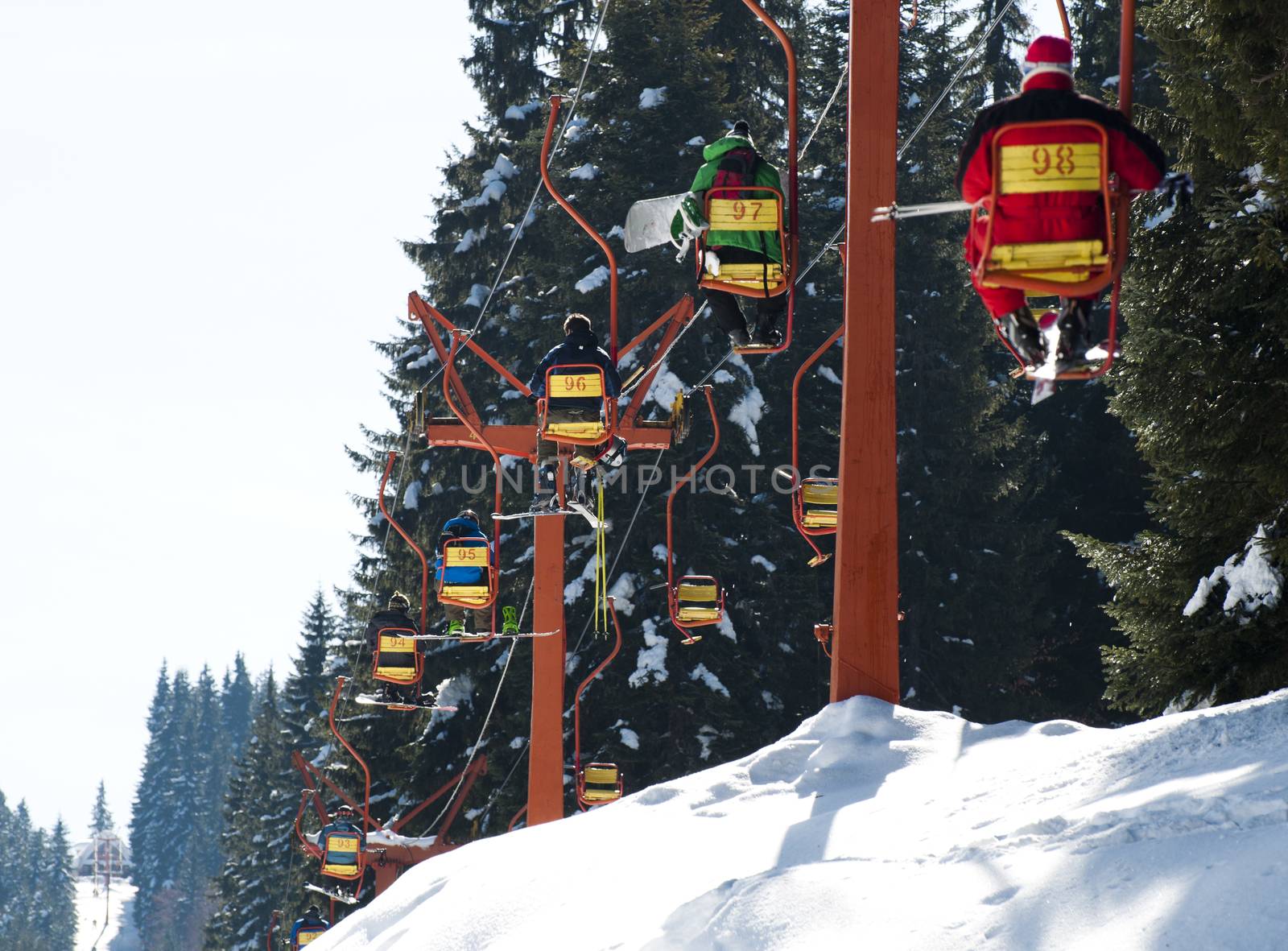 Ski lift and skiers by deyan_georgiev