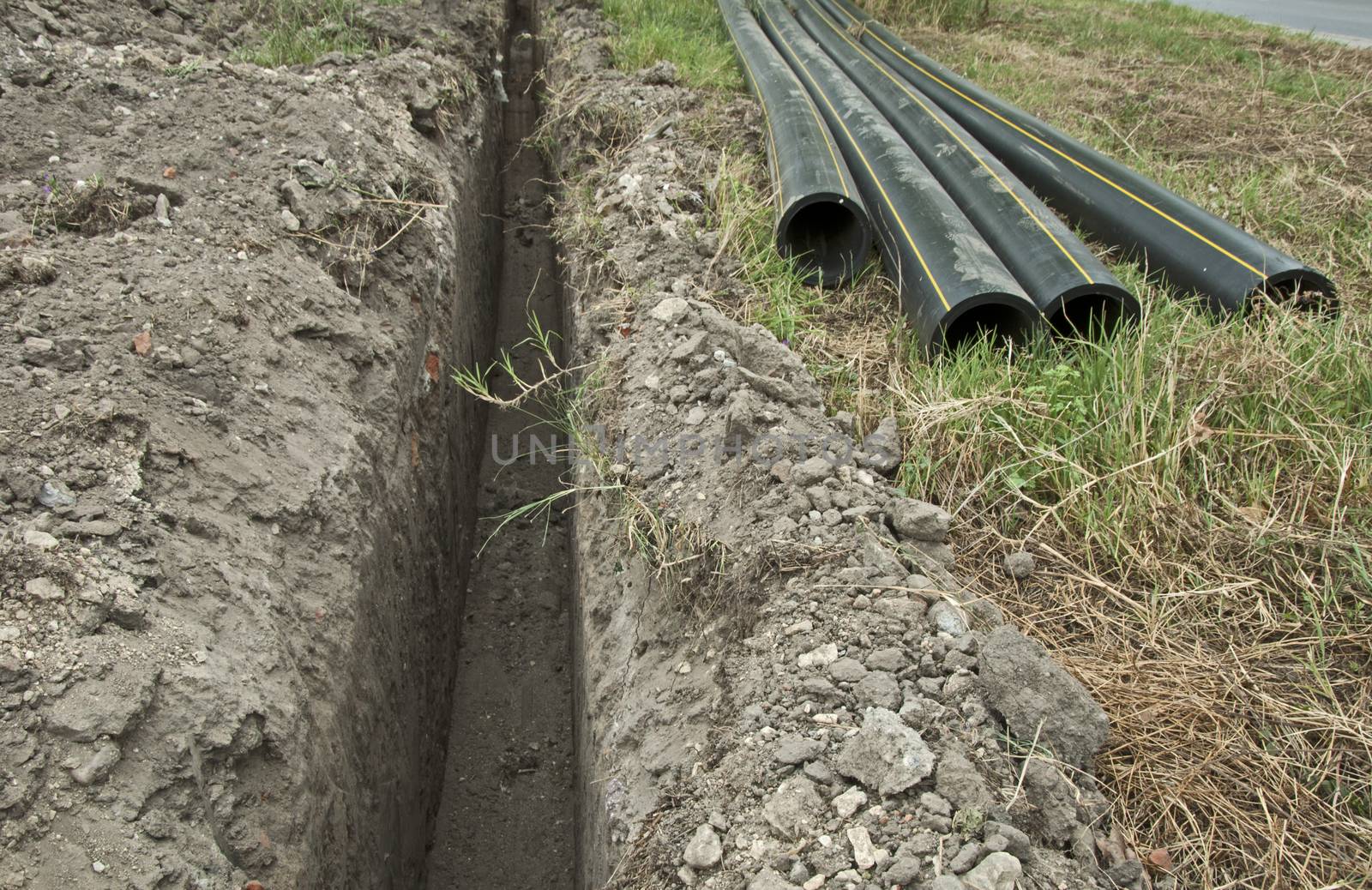 Plastic pipes in a ditch by deyan_georgiev