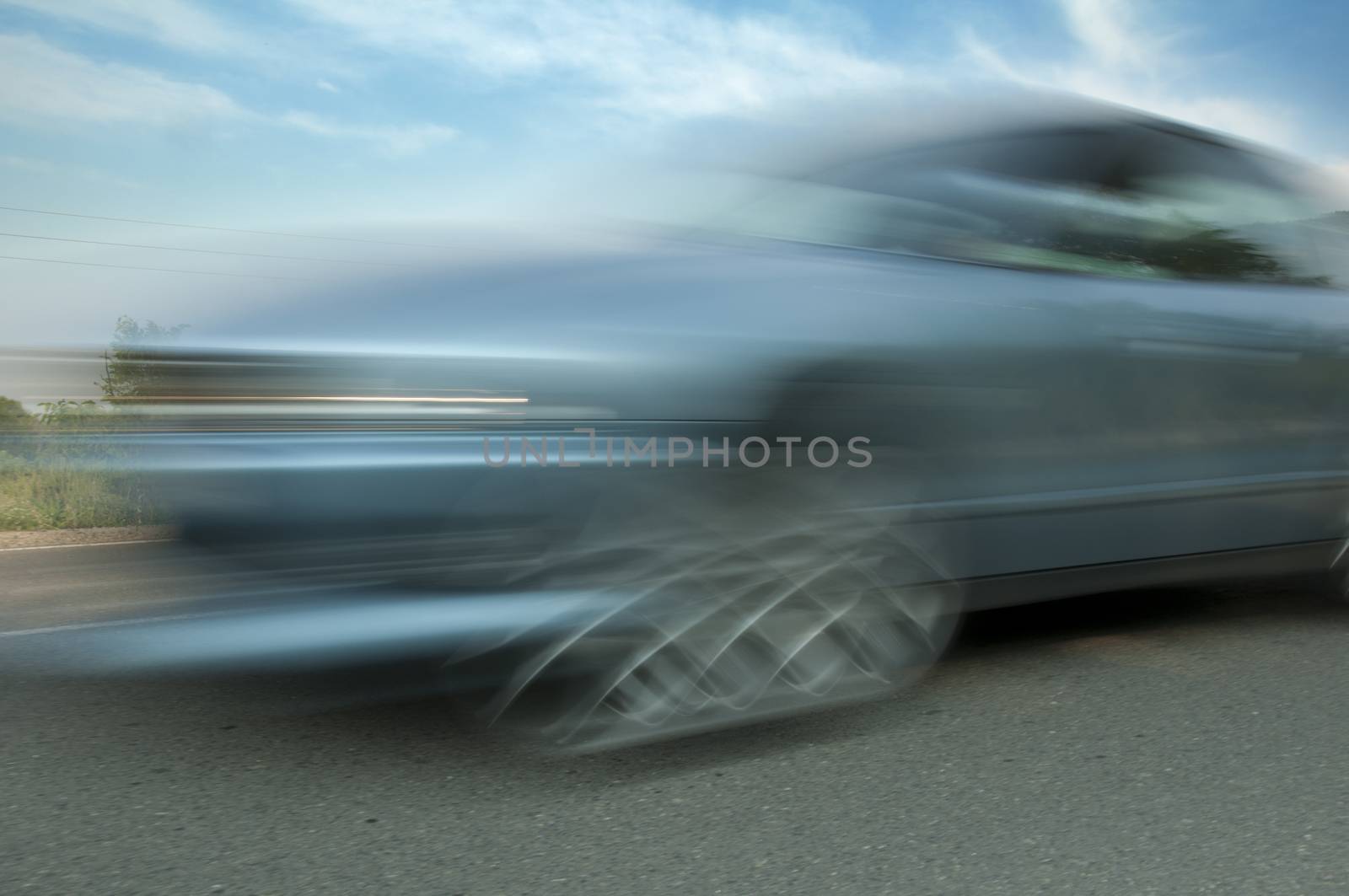 High speed blurred car with blue sky
