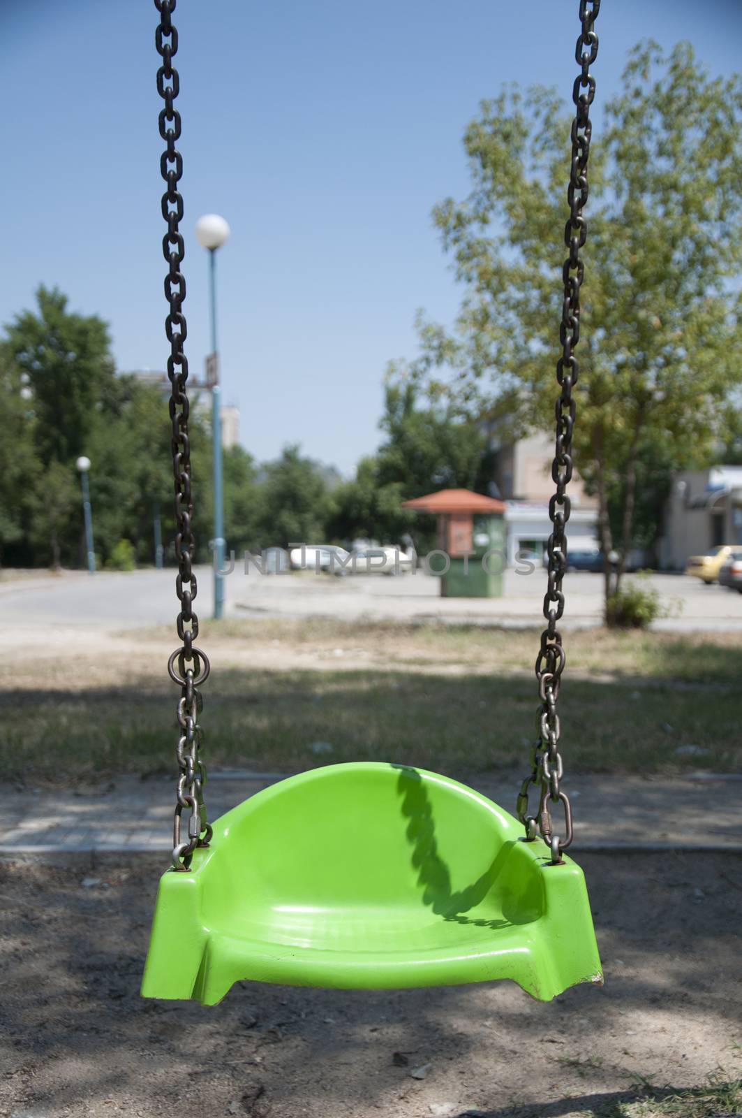 Empty green swing with chain by deyan_georgiev