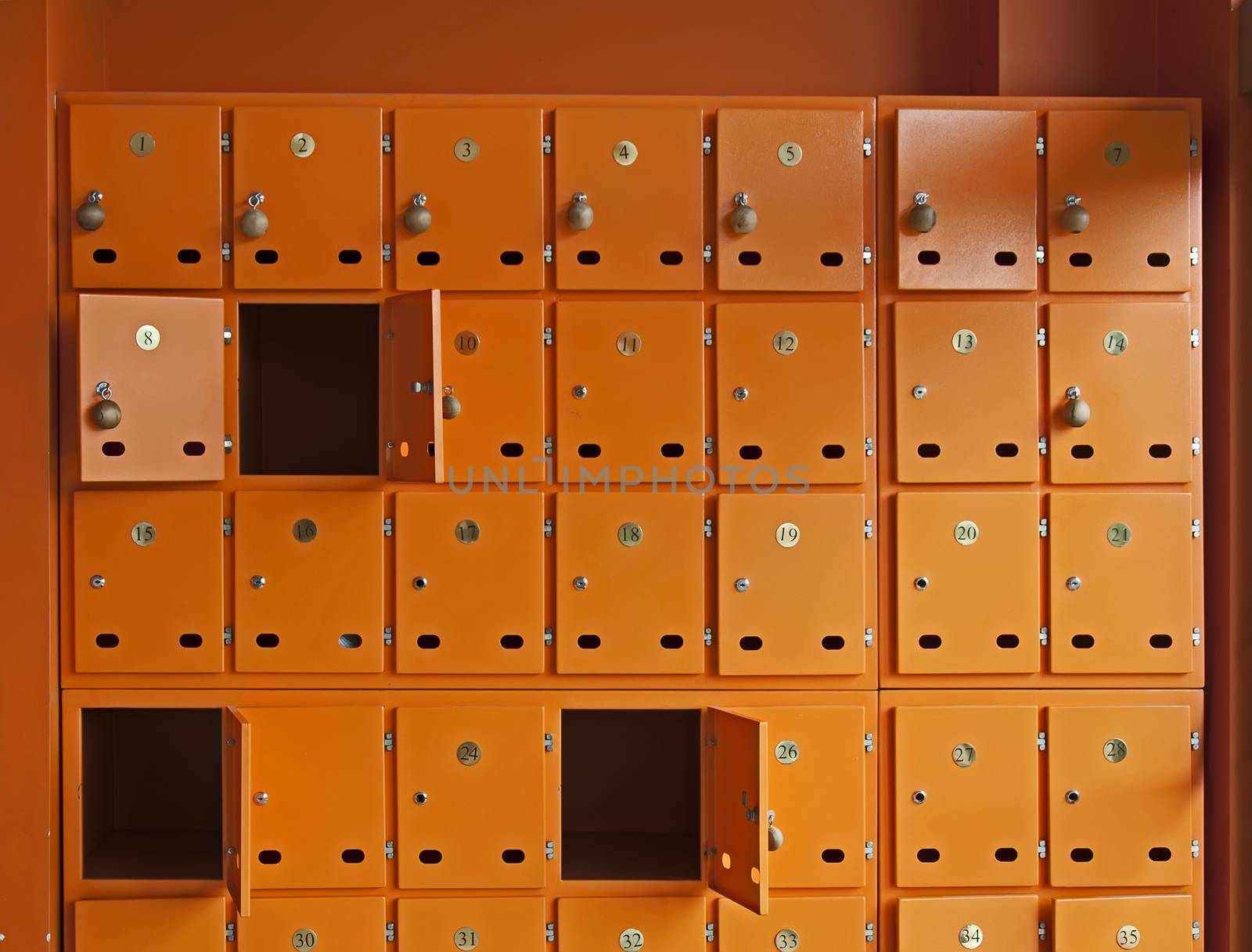 Many orange mailboxes. Some of them opened