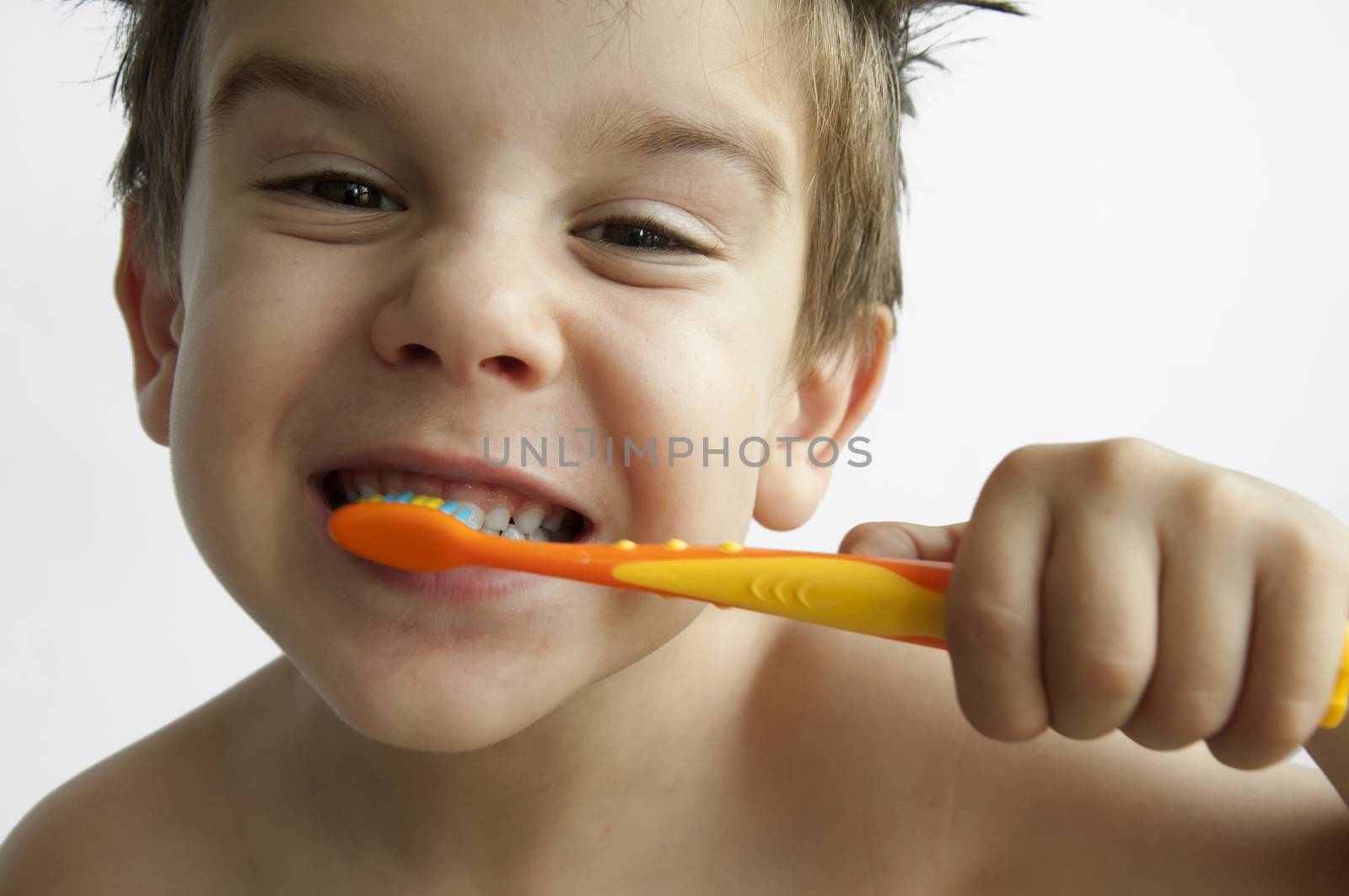 Boy washing teeth with toothbrush