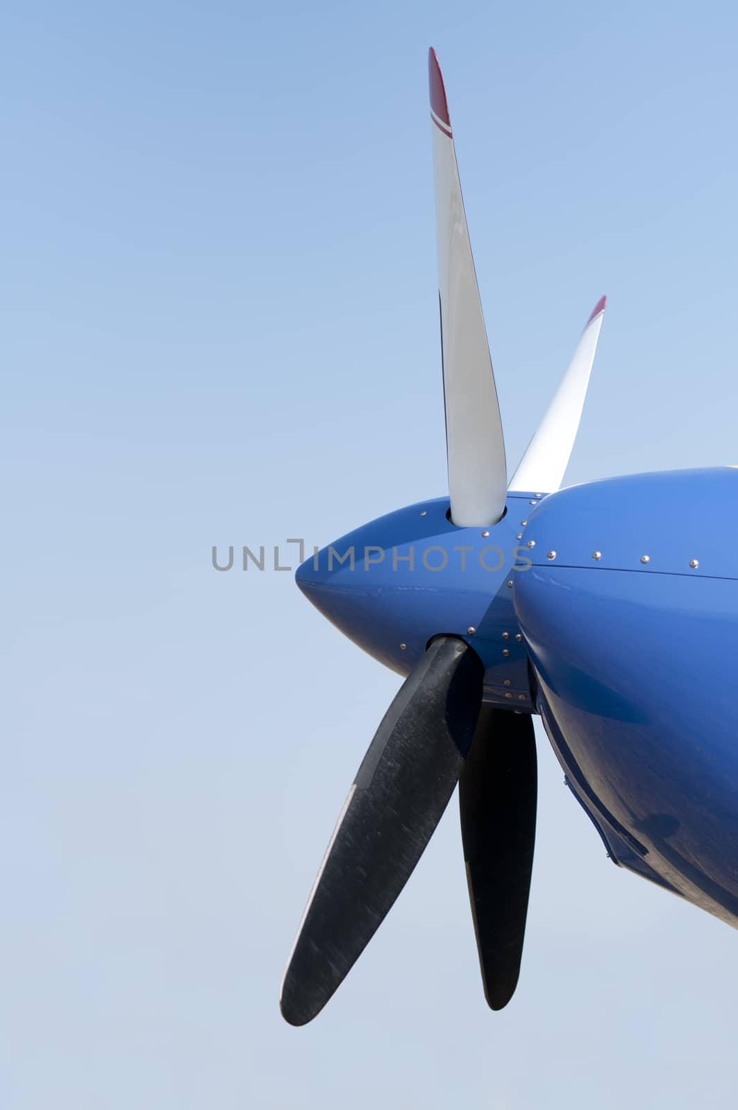 White plane propeller on blue sky background