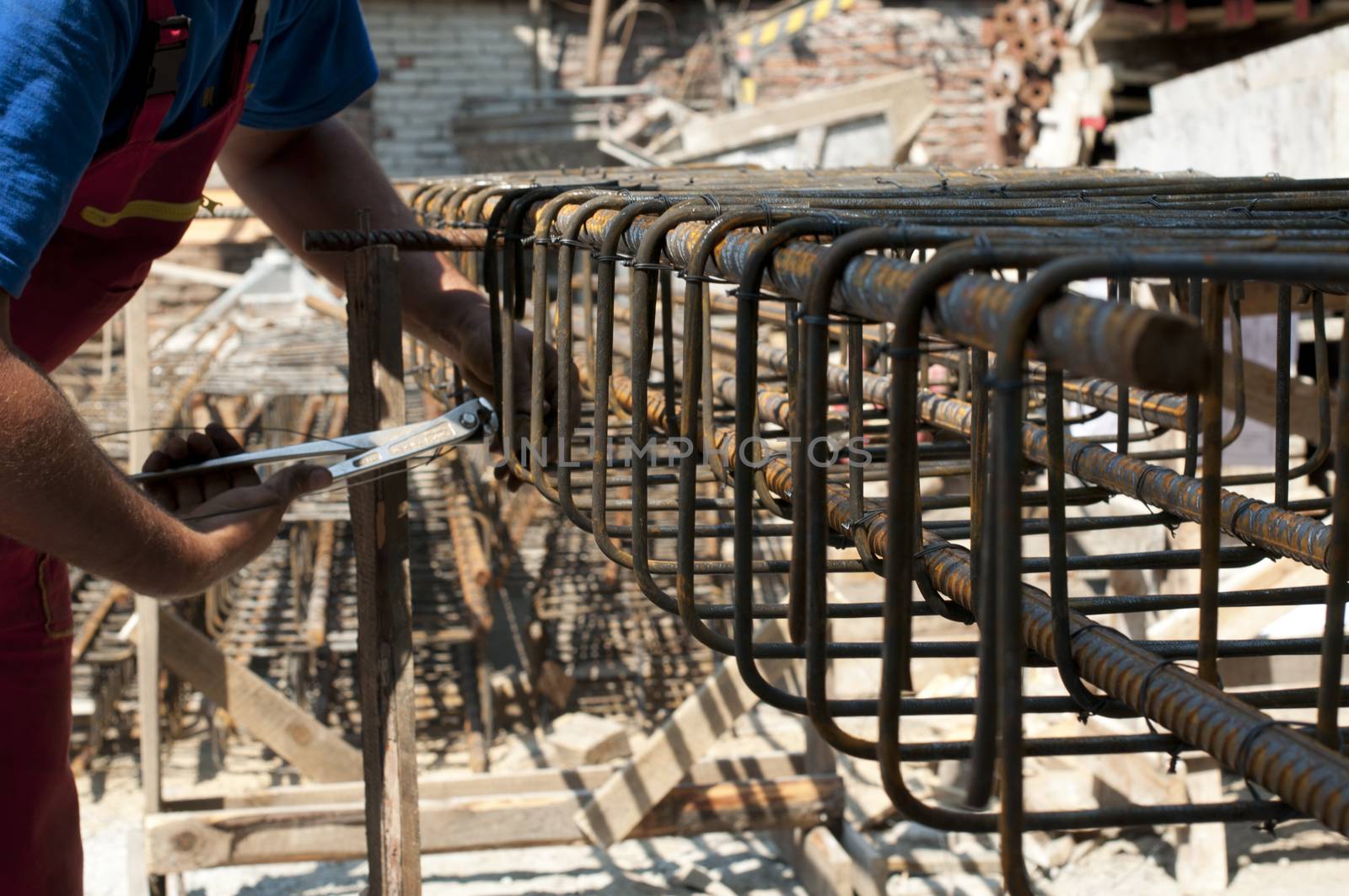 Construction worker ties reinforcing steel by deyan_georgiev