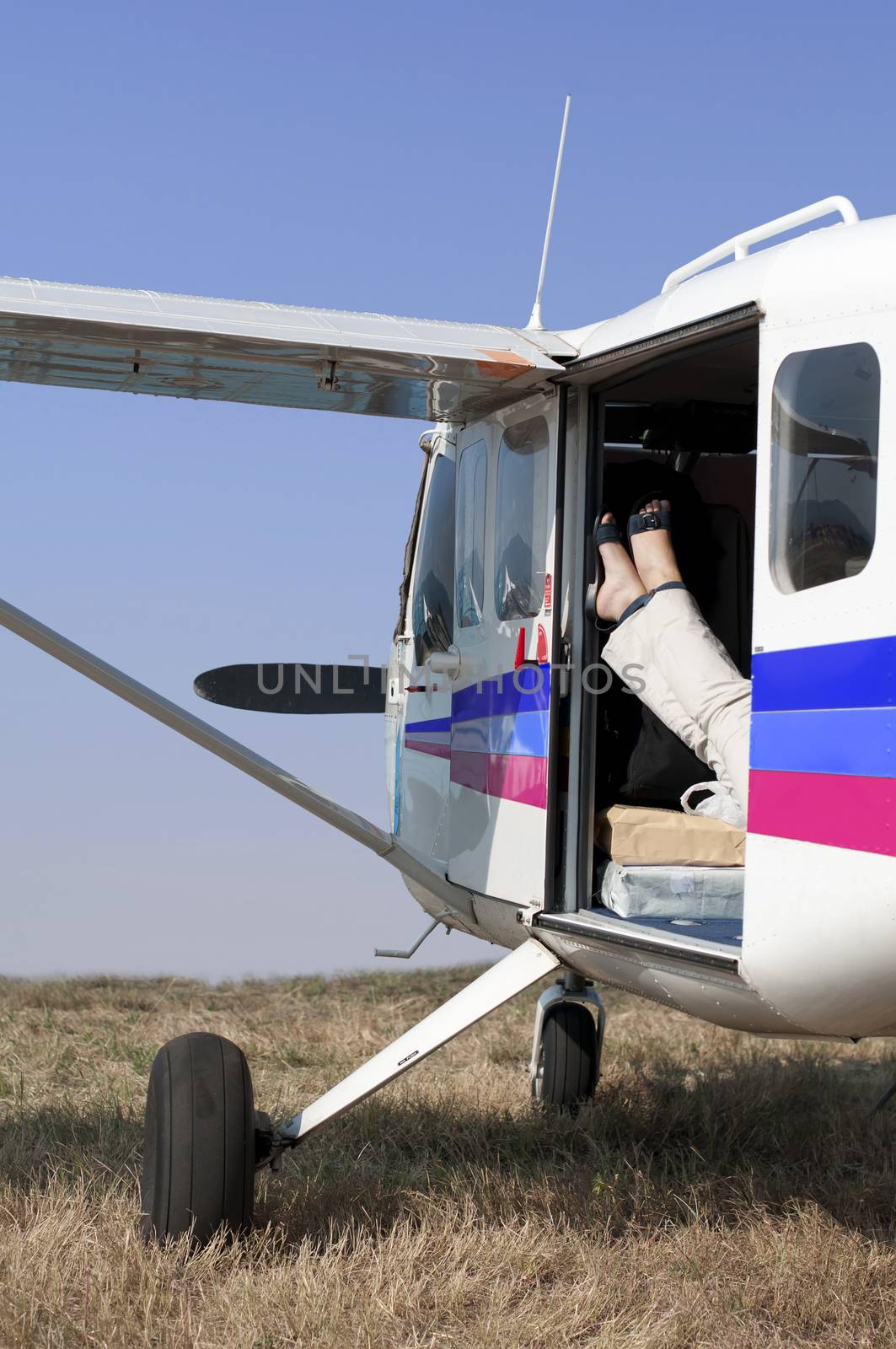 Female legs in a helicopter leaning against the door