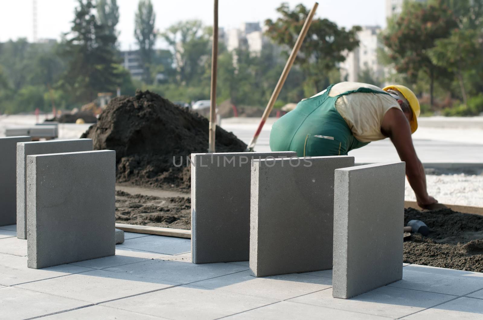 A worker puts exterior tiles  by deyan_georgiev