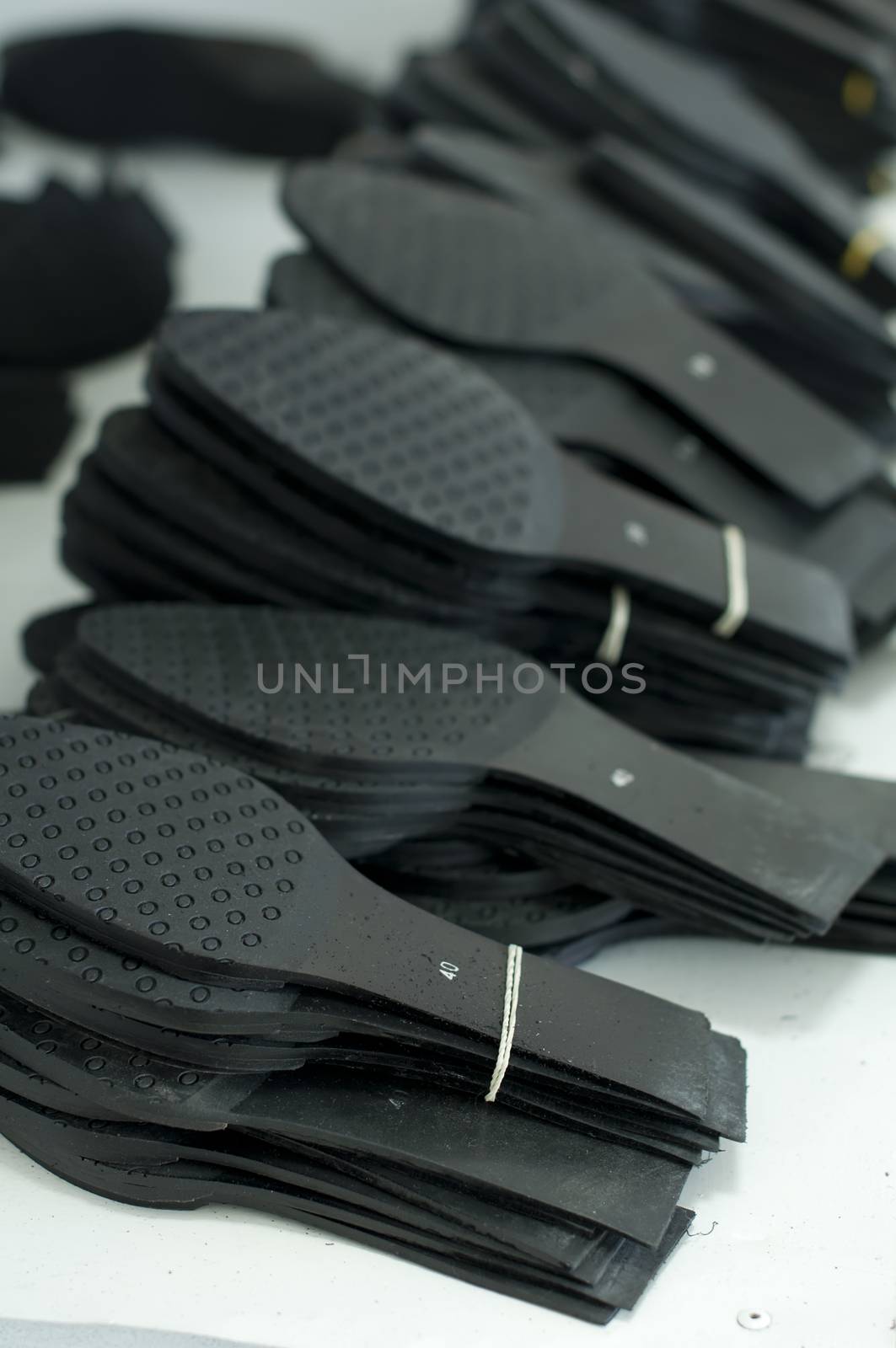 Black shoe soles in a factory