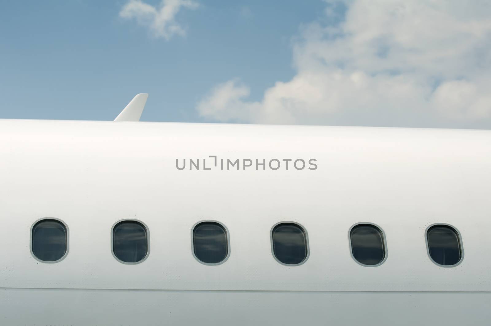 Windows of an airplane outside. White color plane