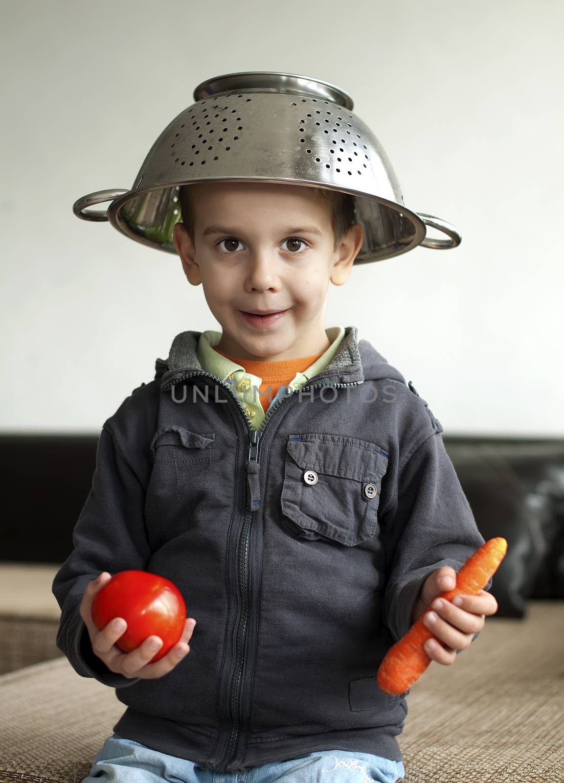 Boy with tomato and carrot in hand by deyan_georgiev