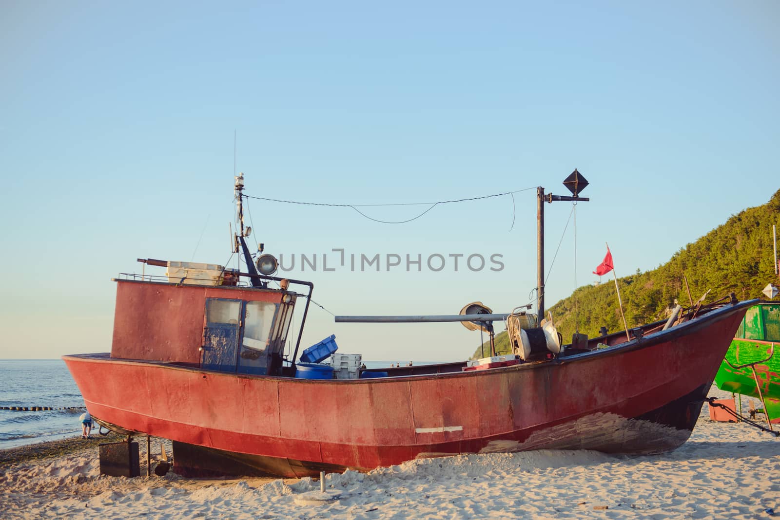 fisherman boats at sunrise time on the beach in summer