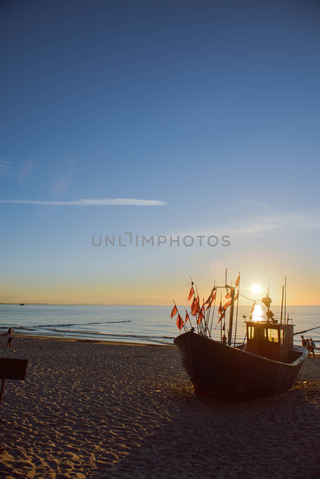fisherman boats at sunrise time on the beach in summer