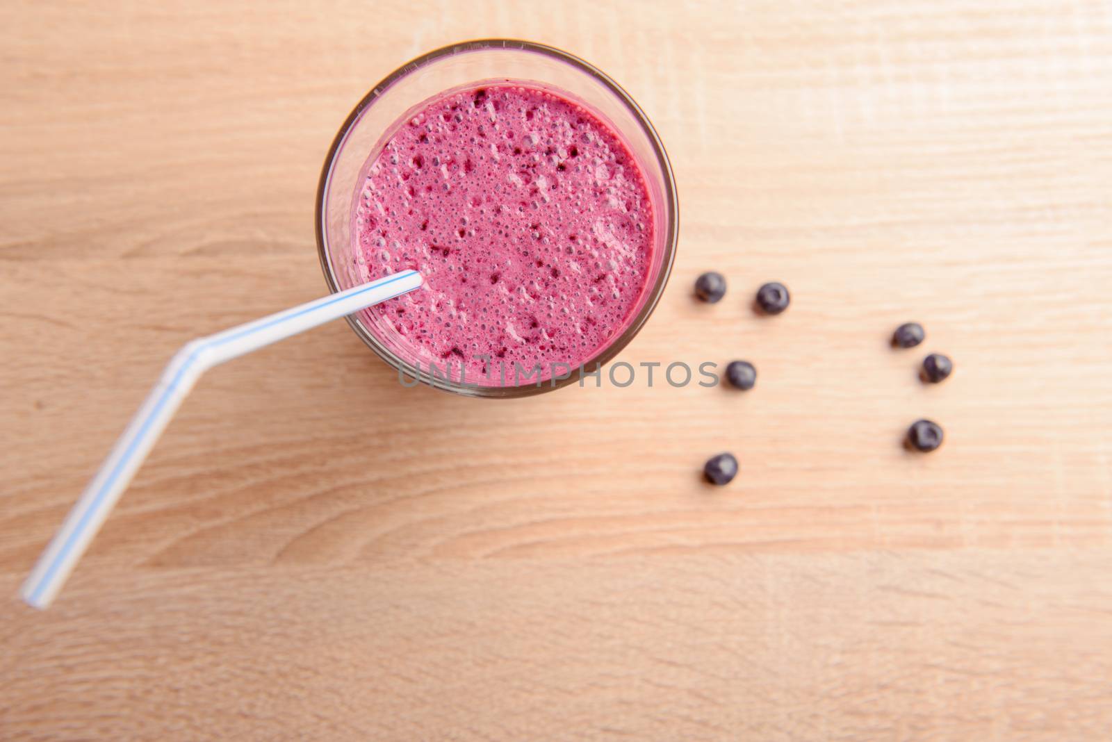 Blueberry smoothie with fresh berries, chia seeds and banana for breakfast on rustic wooden background, selective focus
