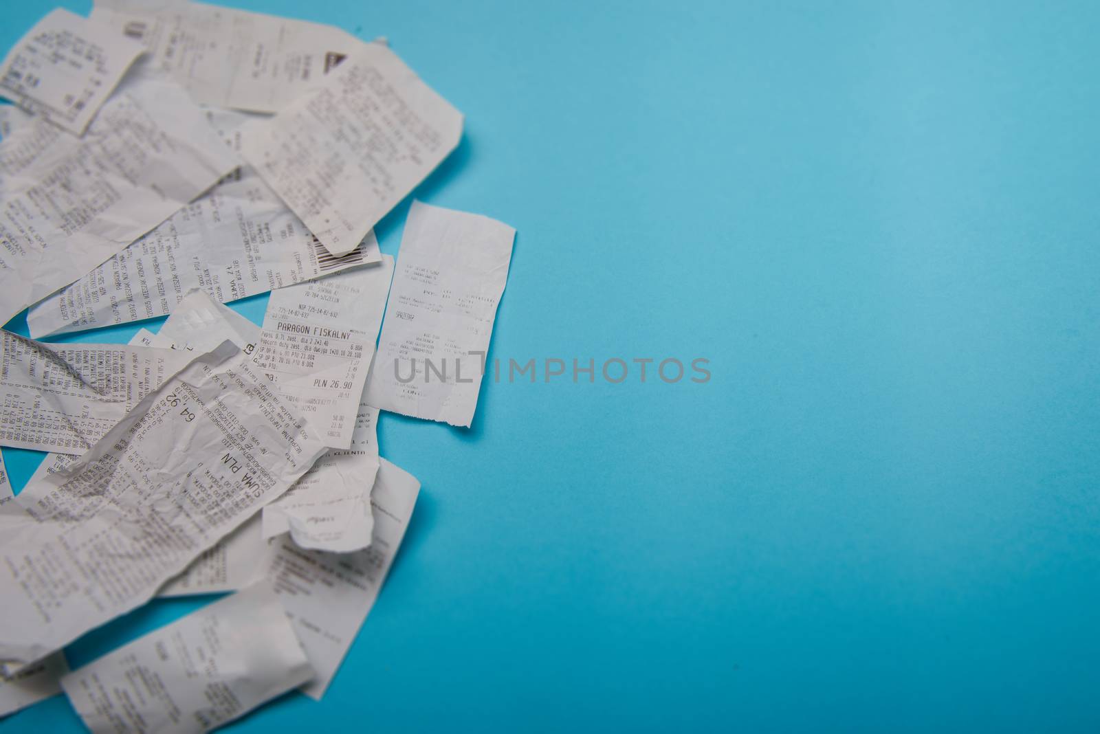 Pile of shopping receipts on a blue background