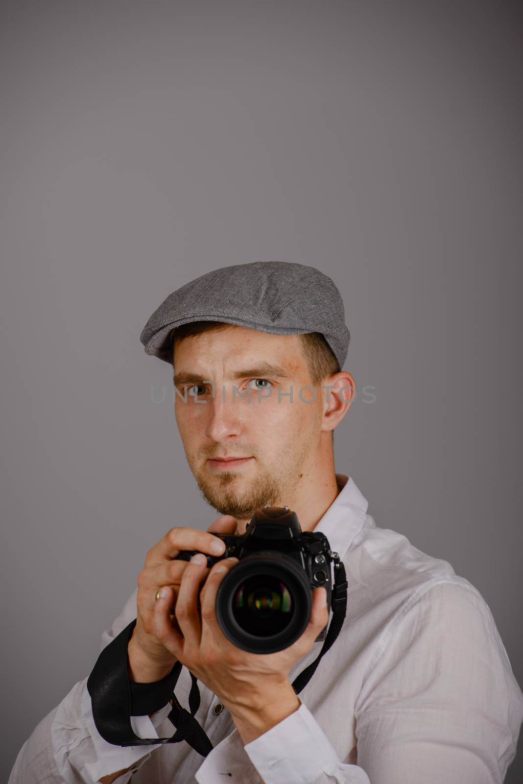 Young man using a professional camera in studio