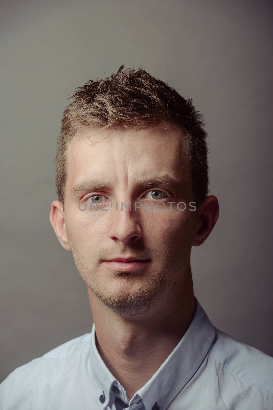 Portrait of a smart serious young man.