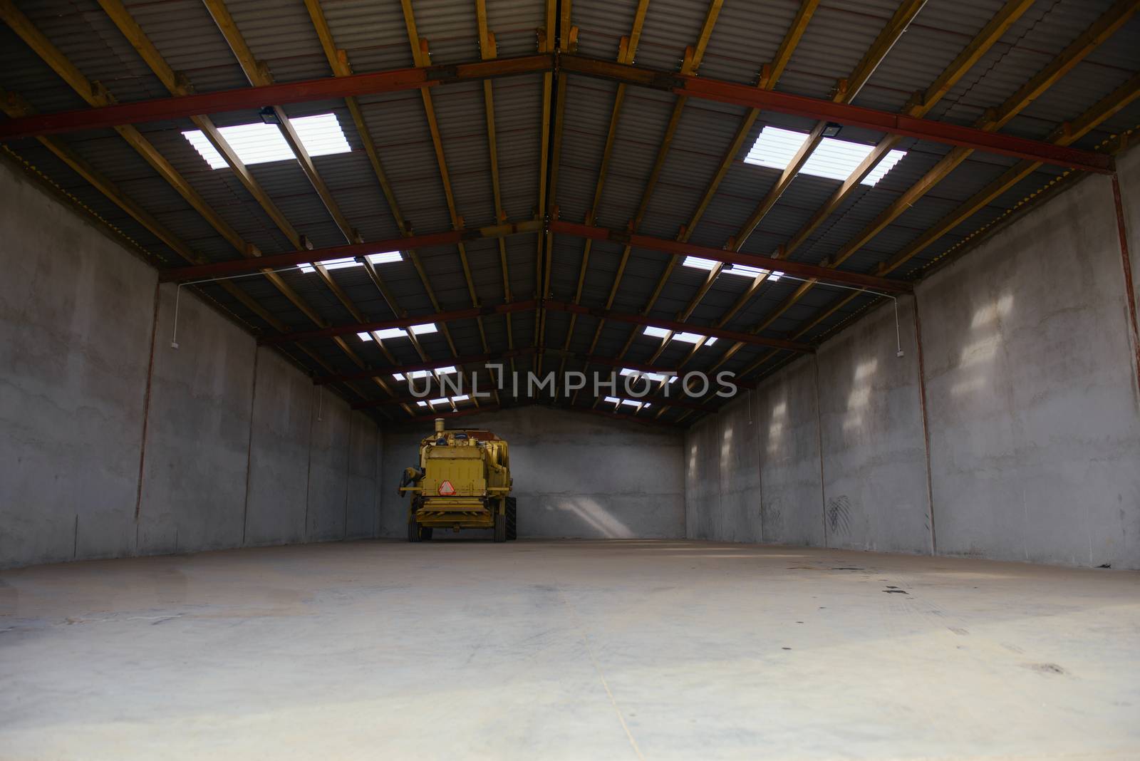 combine harvester standing ready for harvest in a warehouse