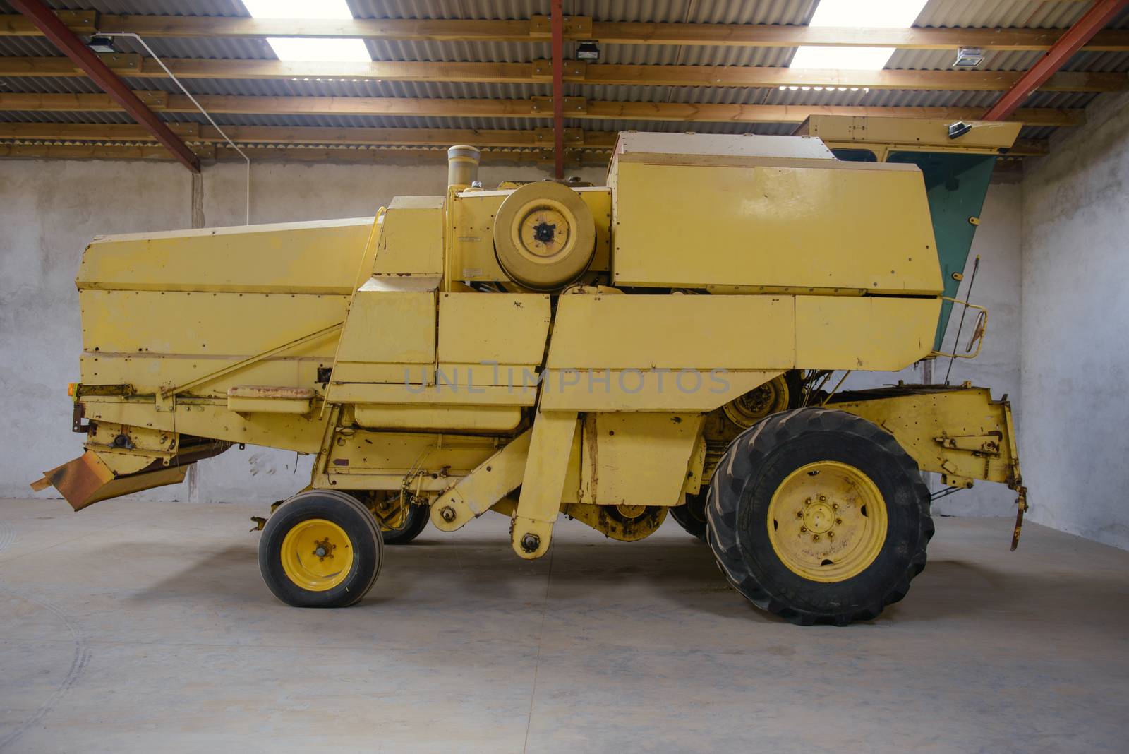 combine harvester standing ready for harvest in a warehouse