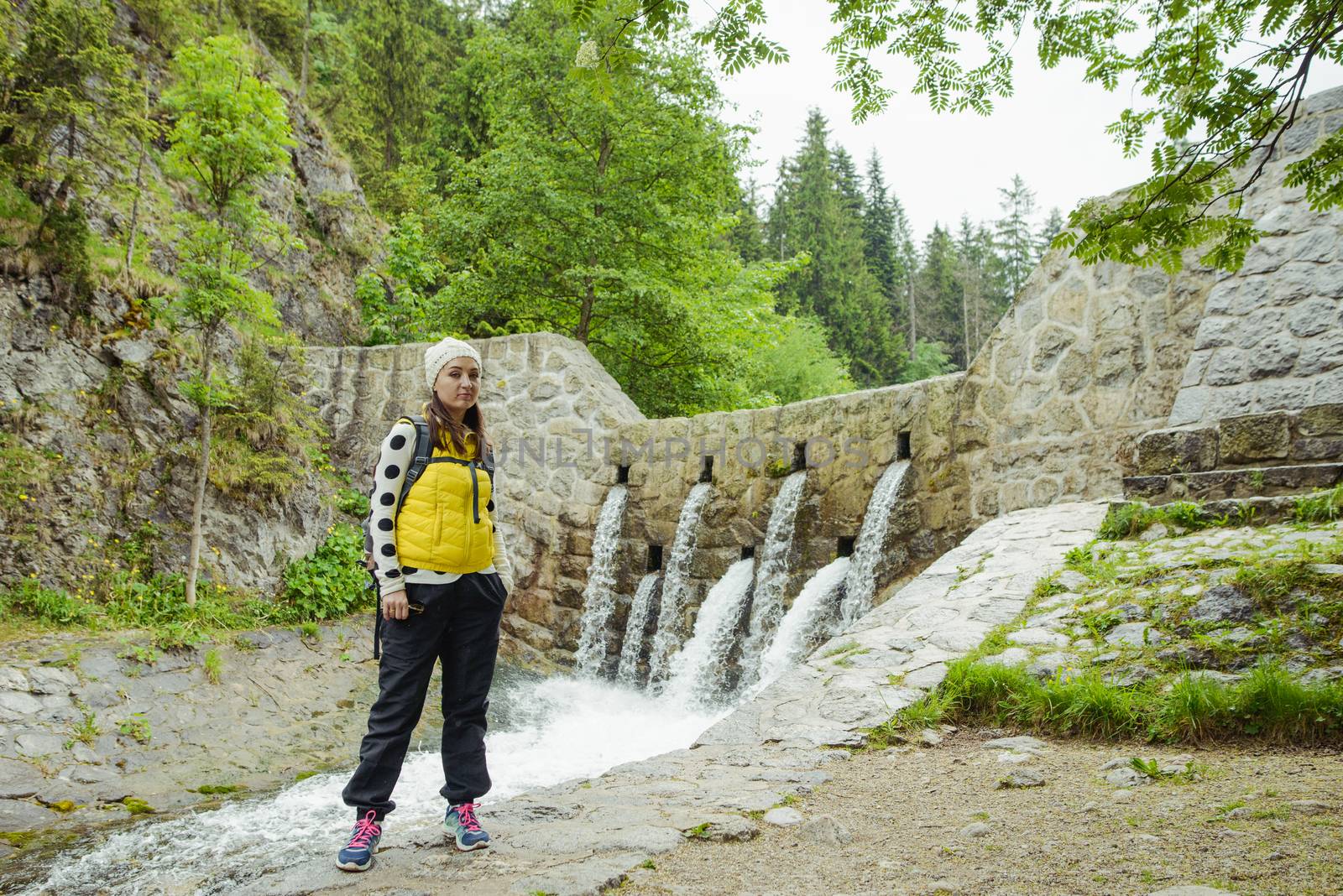 brunette woman hiker hiking on trail in summer time. Tatra mountain in Poland.