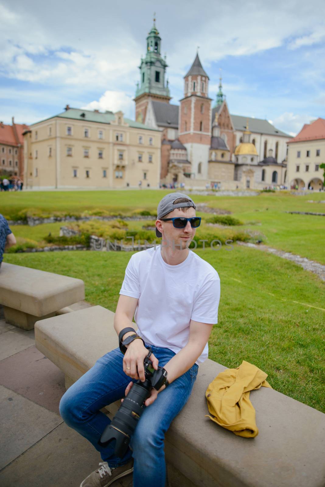 Man during sightseeing old castle in Cracow, Wawel. by Brejeq