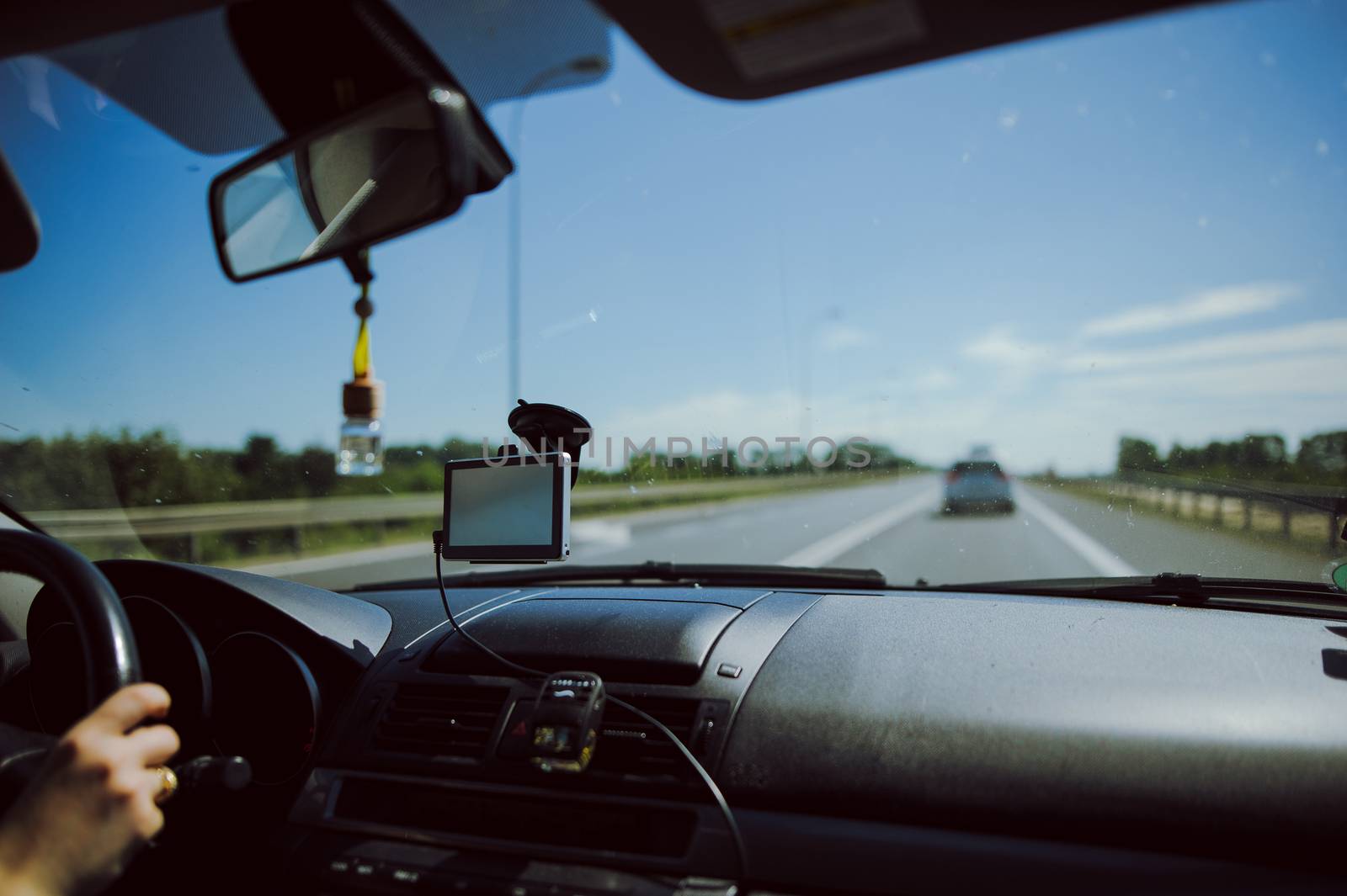 car and blue sky with blurred clouds.