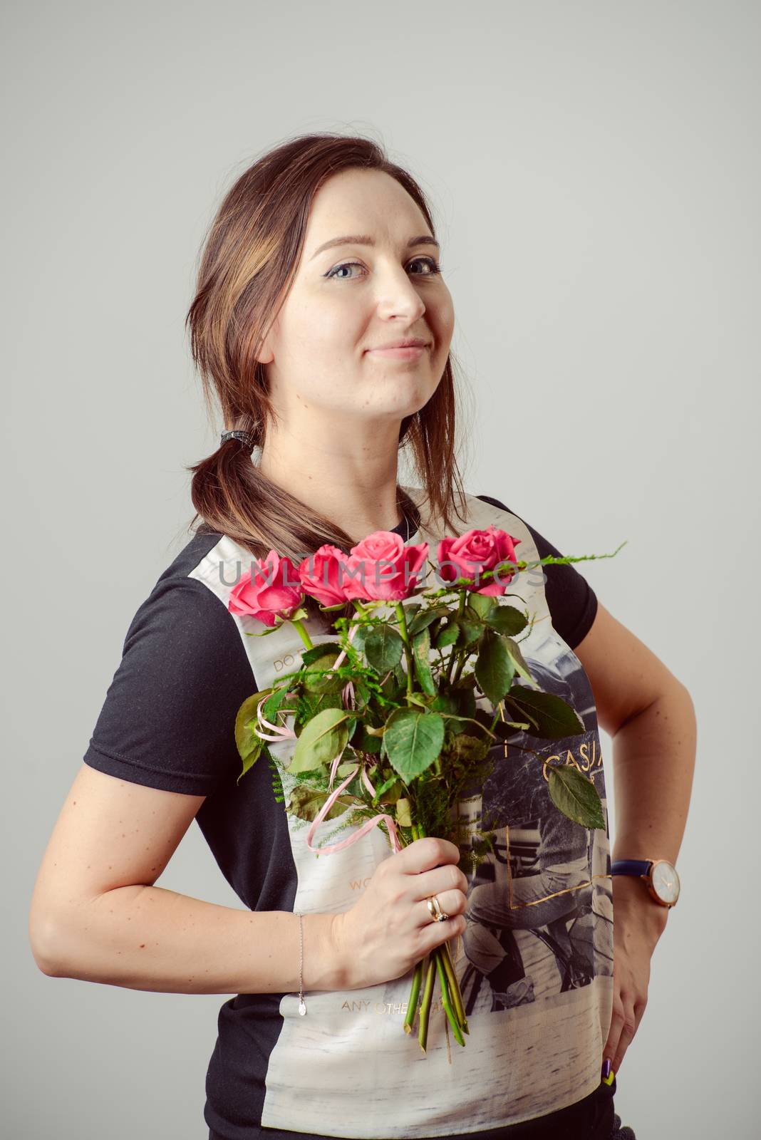 portrait of young charming girl with a bouquet of roses Valentine's Day
