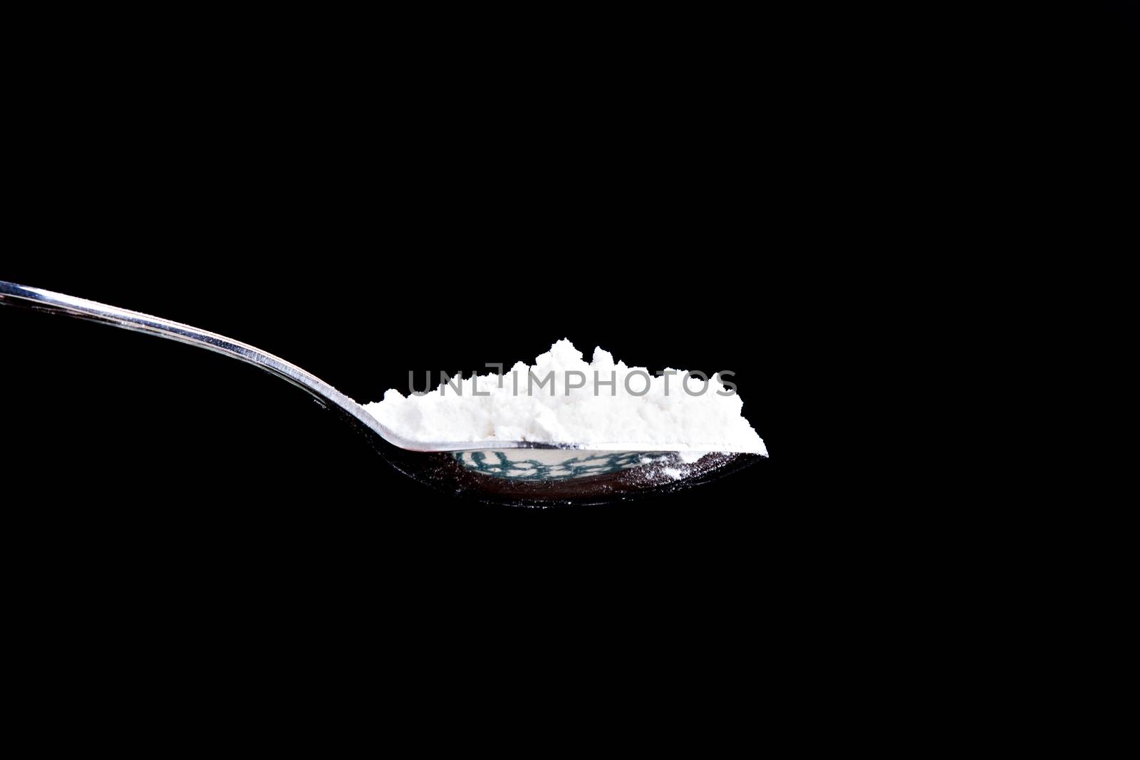 Isolated spoon of white powder. Can be flour, wheat, of some sort of drug.