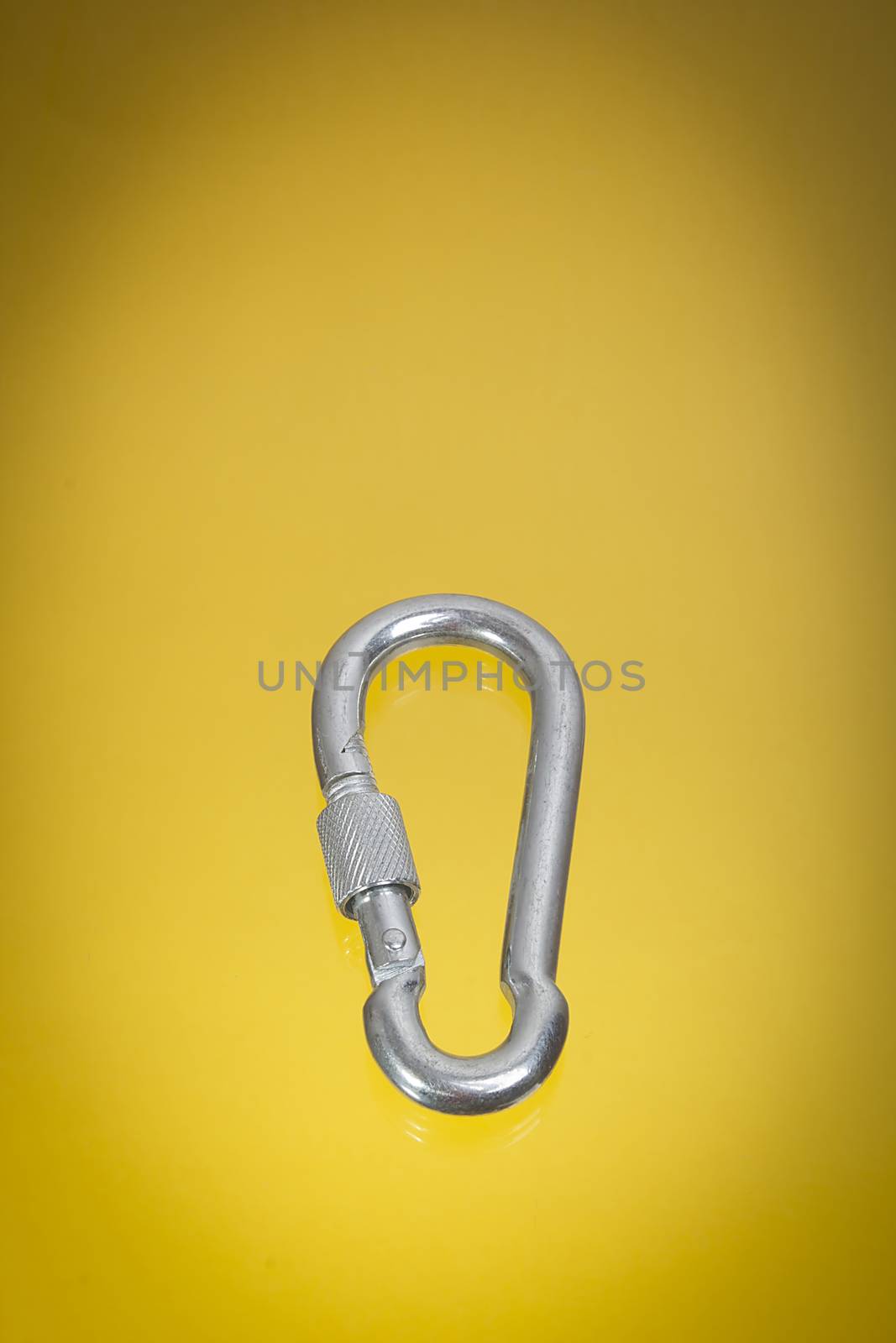 Aluminum climbing carbine on a yellow background