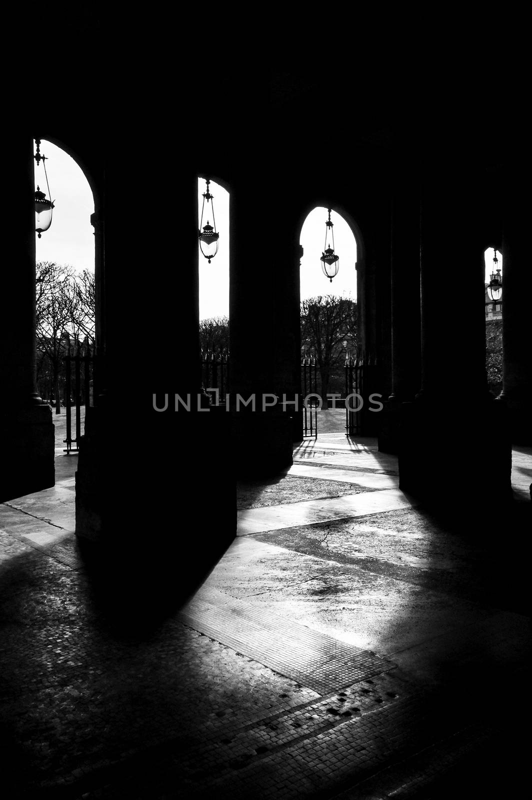 The Palais-Royal arcades in Paris, France. Black and white photography.