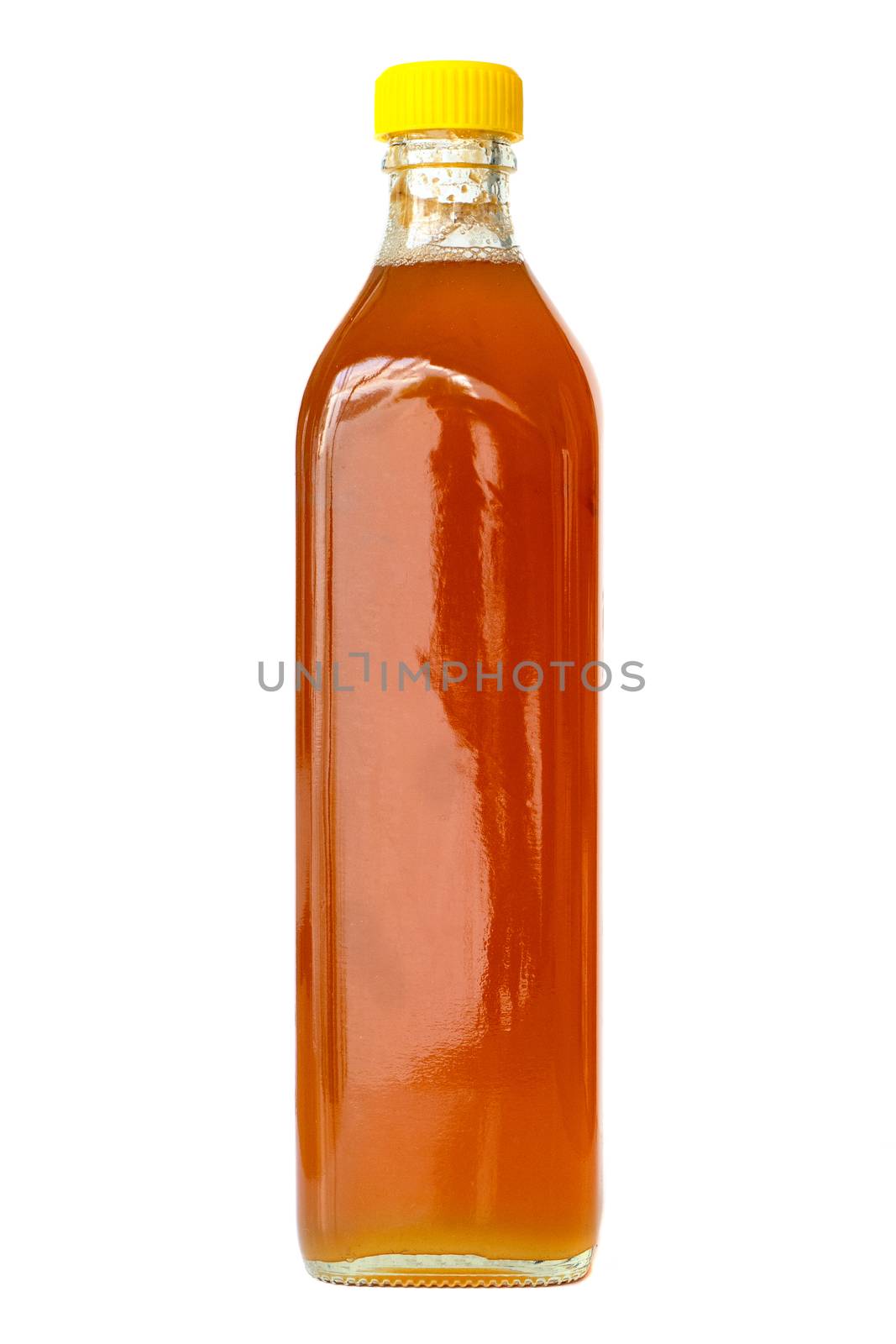 Raw unprocessed honey in glass bottle, isolated on white background.