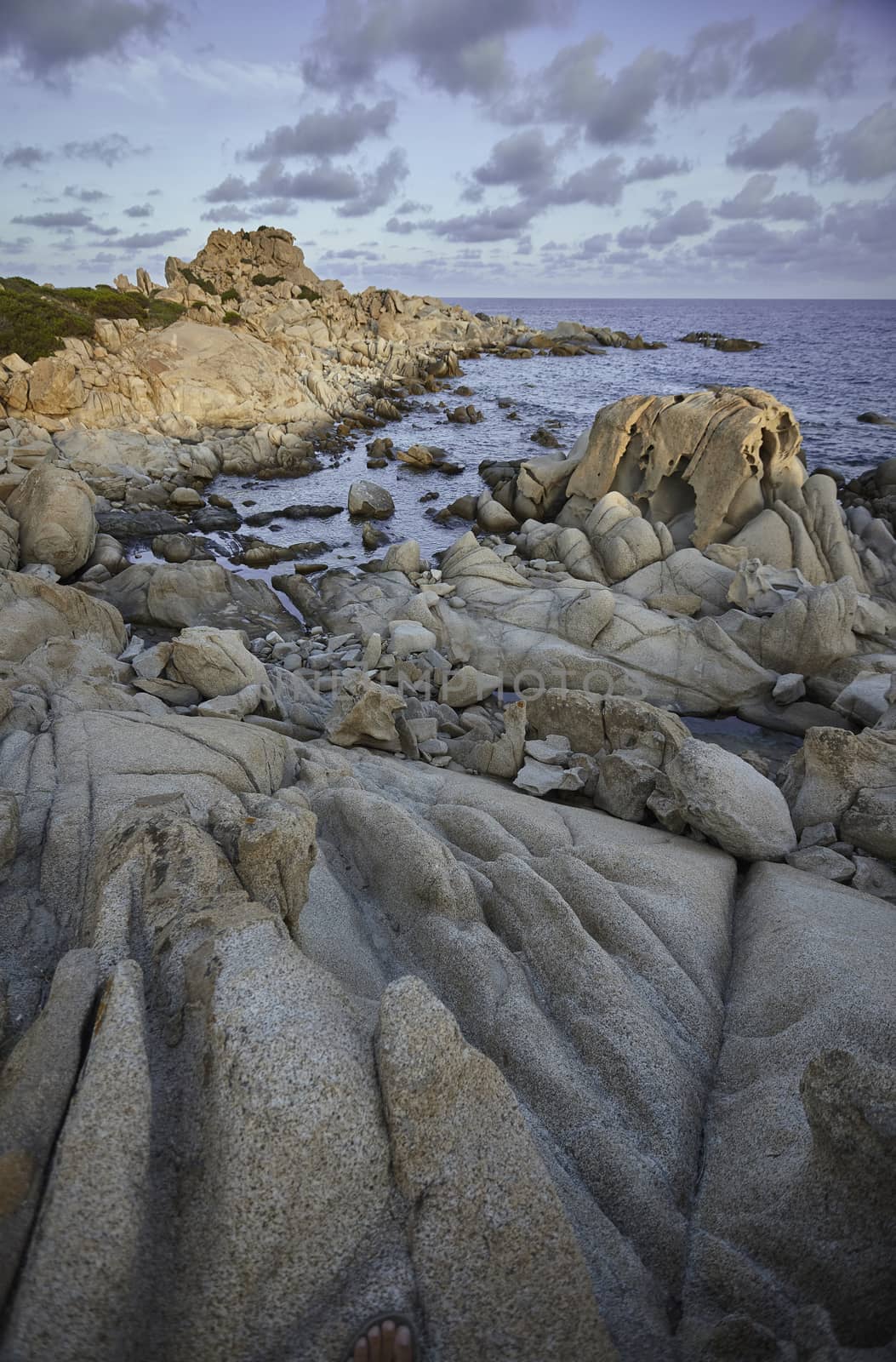 Beautiful cliff on the southern coast of Sardinia, formed by granite rock shaped by the sea and the elements. Vertical Shot.