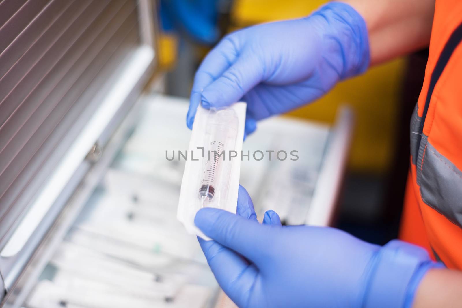 urgency doctor preparing syringe in the ambulance