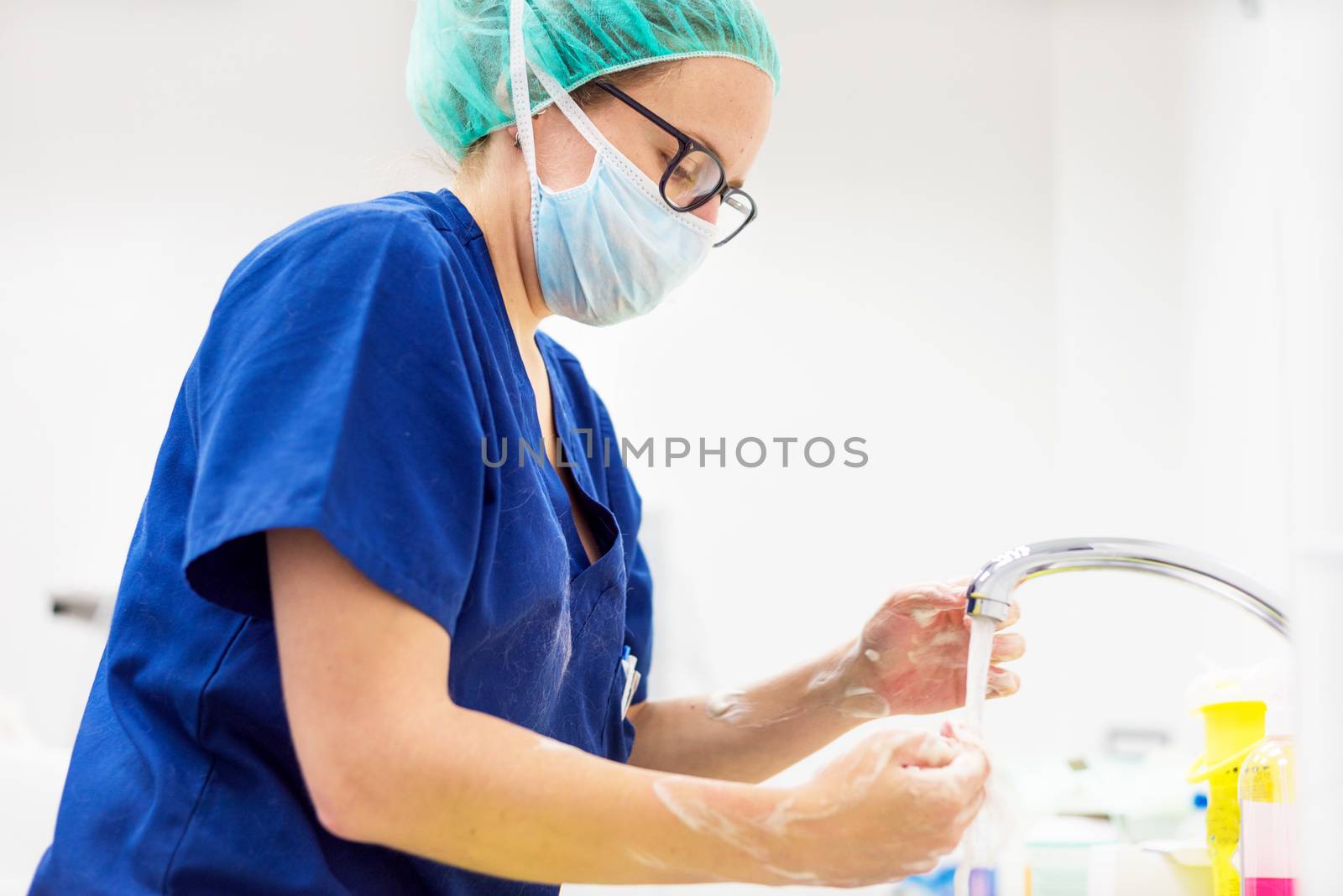 Veterinary surgeon washing hands before operating by HERRAEZ
