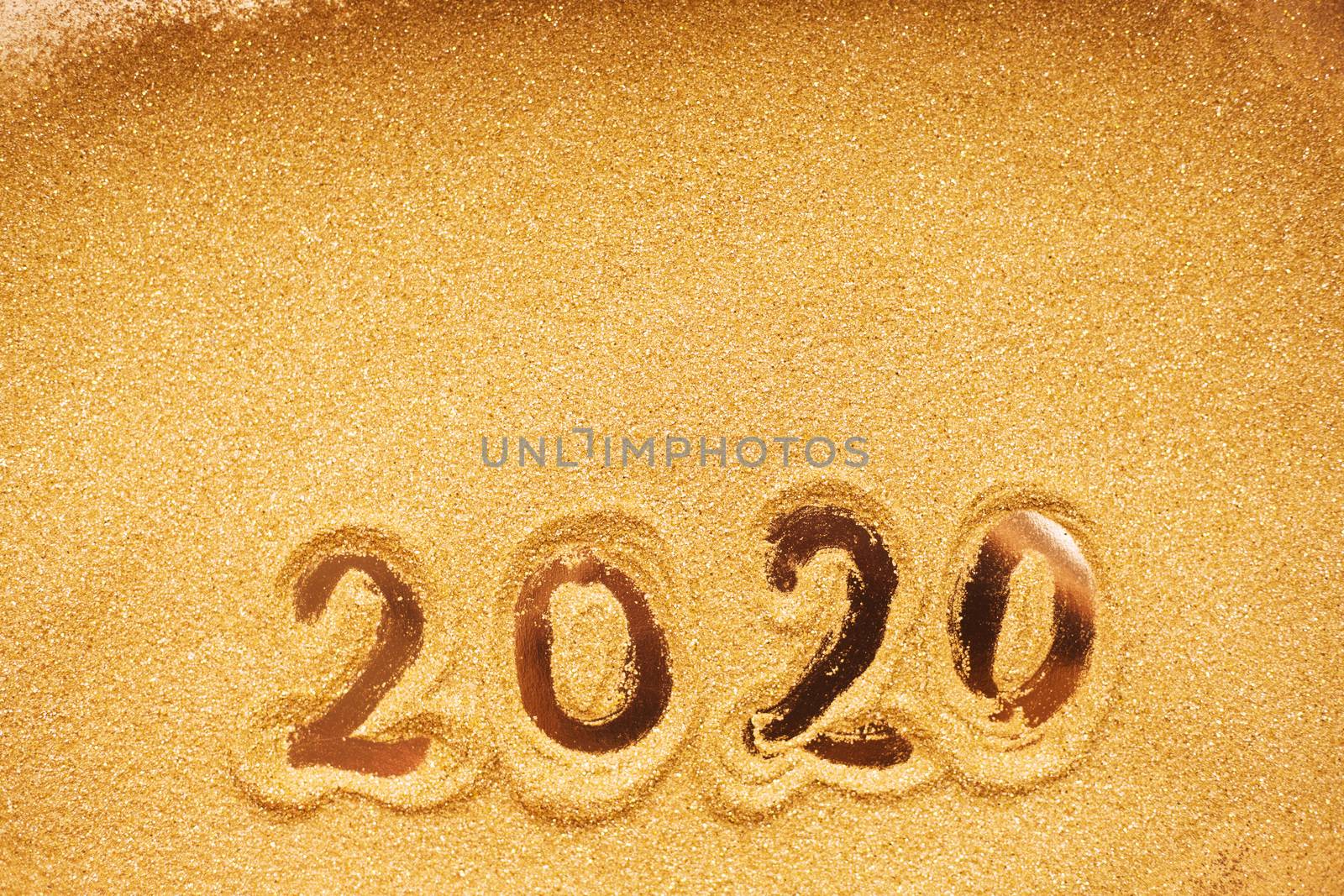 Hand drawn2020 Happy new year symbol on golden glitter background