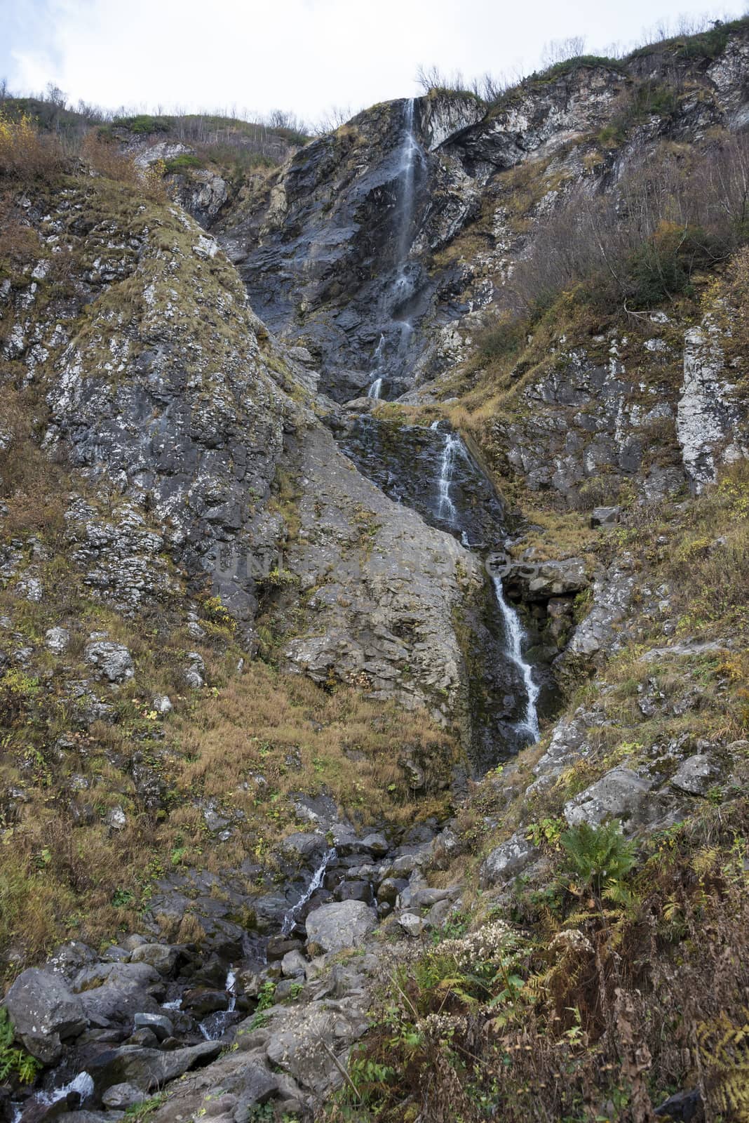 Polikarya waterfall in the Caucasus mountains near Sochi, Russia. Cloudy day 26 October 2019.