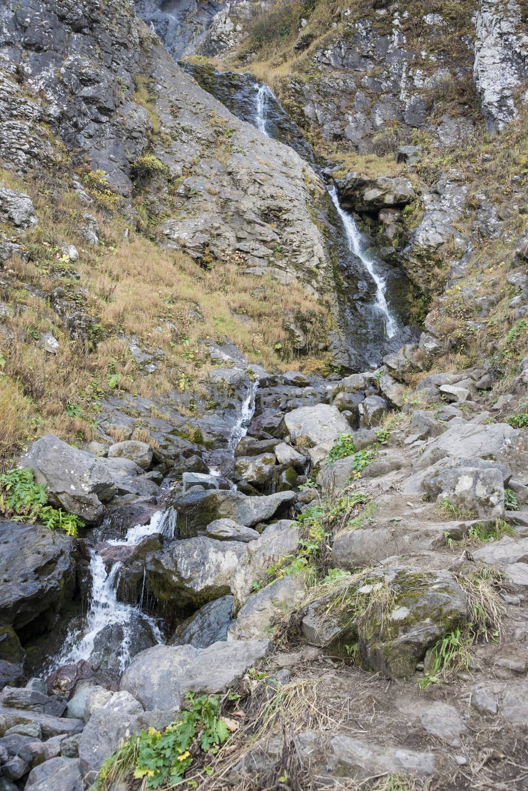 Polikarya waterfall in the Caucasus mountains near Sochi, Russia. Cloudy day 26 October 2019.