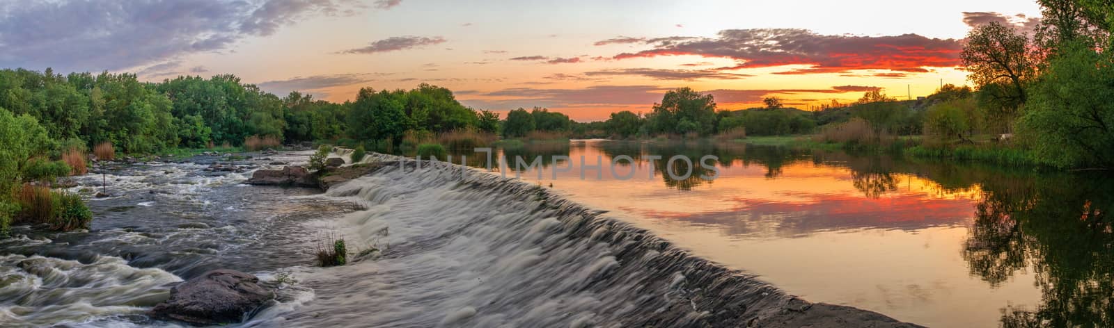 Beautiful view of the dam on the river at sunset by Multipedia