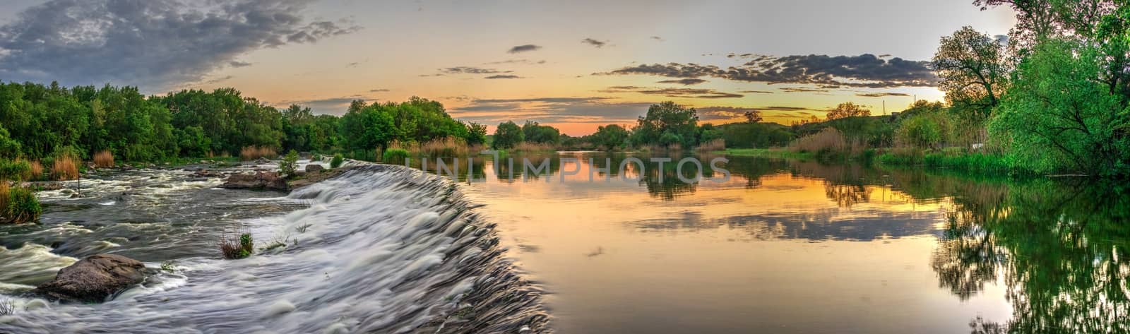 Beautiful view of the dam on the river at sunset by Multipedia