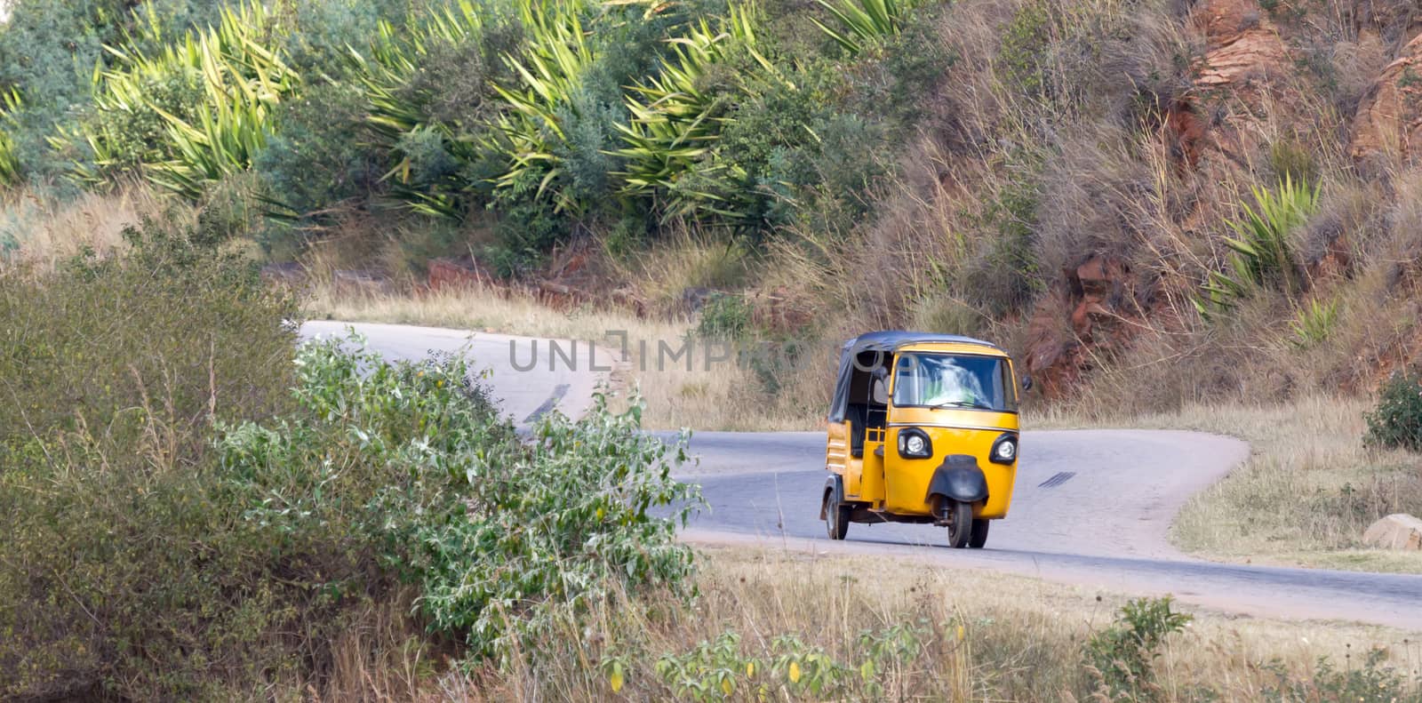 Tuktuk taxi on Madagascar, moving through the mountains